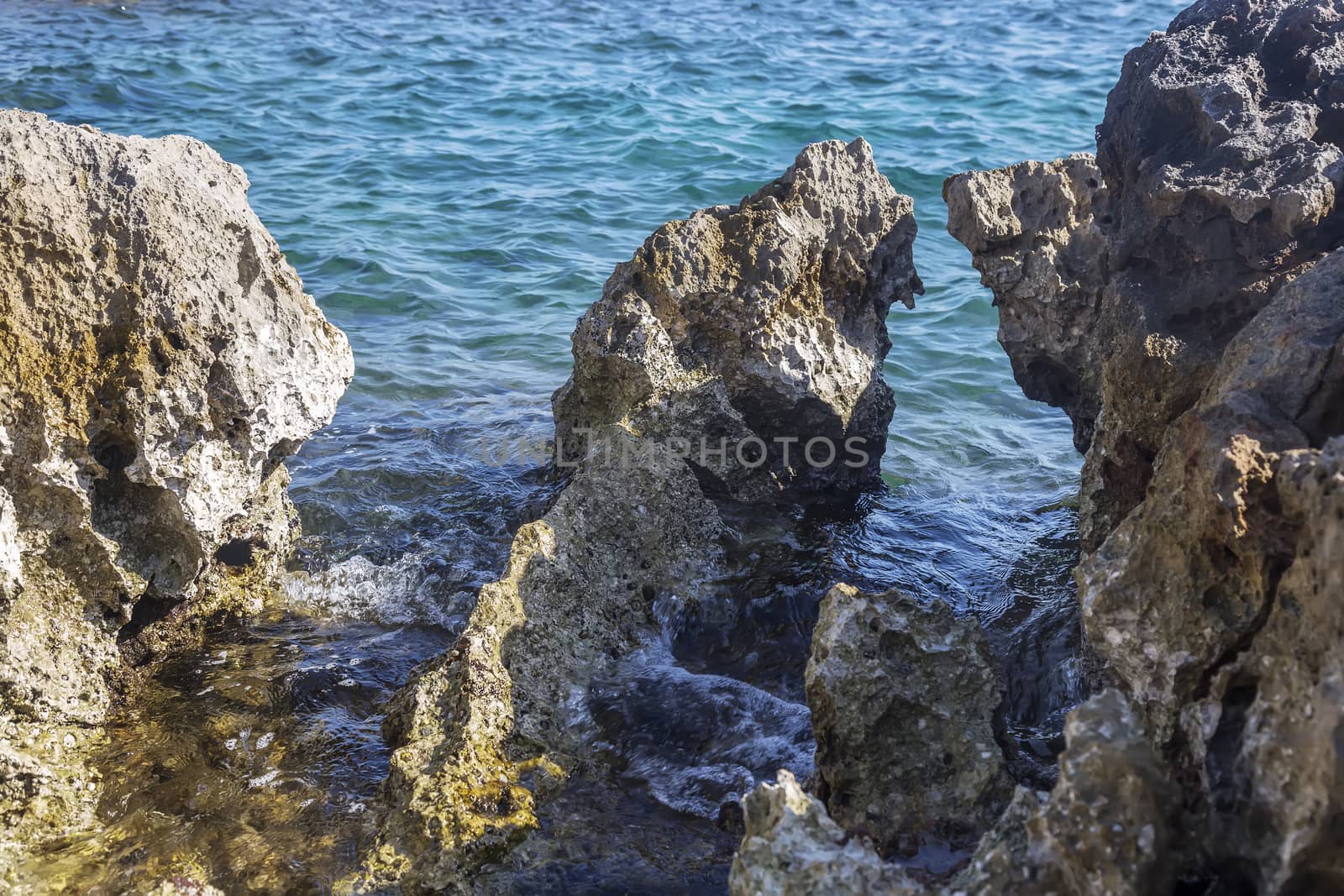 rugged limestone rocks and blue sea