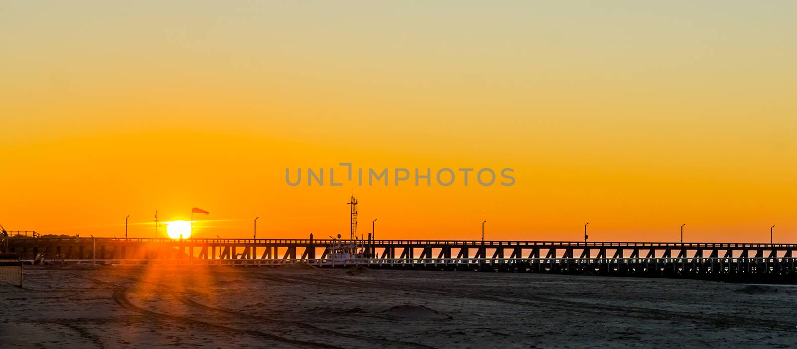 long pier at sunset on the beach of Blankenberge, Belgium, sunset with a colorful sky
