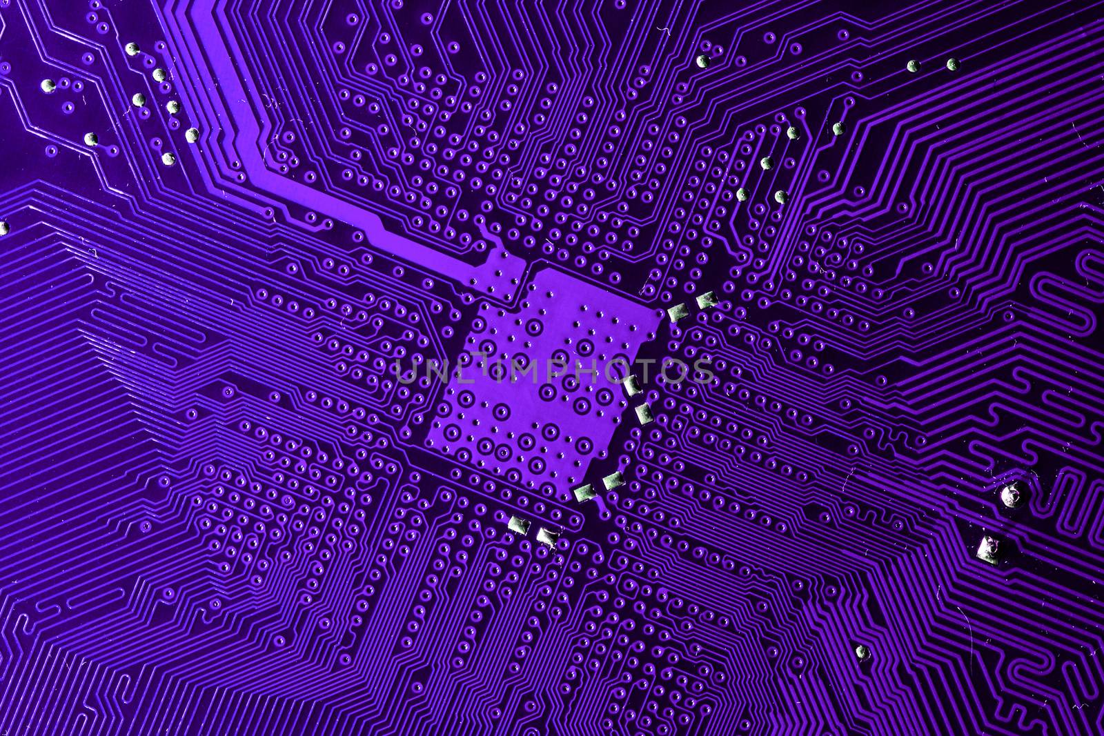 Close up photo of purple printecd circuit board with solder points