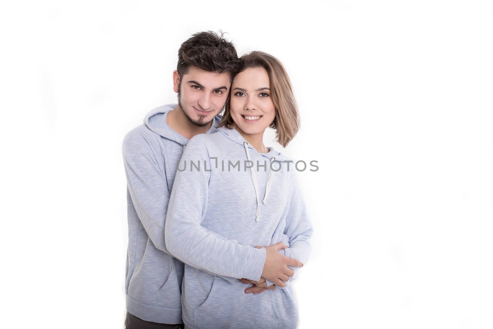 Happy young couple embracing each other and kissing isolated on white