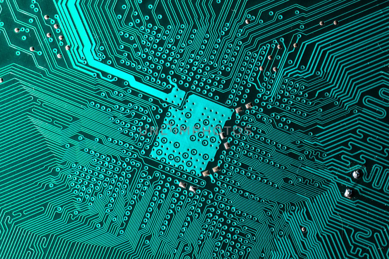 Close up photo of teal printecd circuit board with solder points