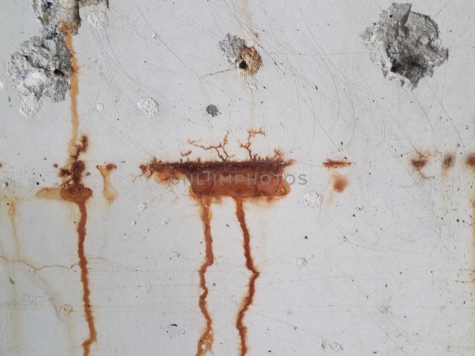 grey cement wall with red rust dripping down by stockphotofan1