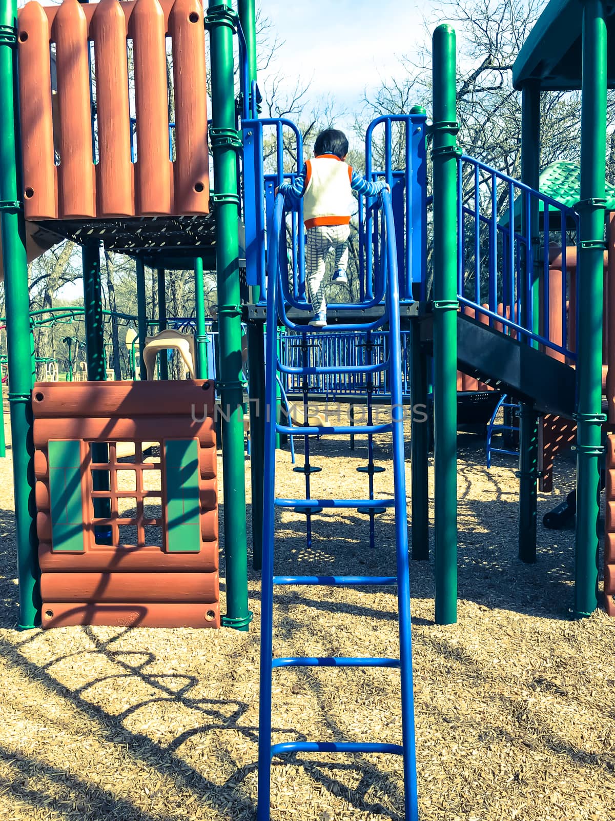 Outdoor playground with children playing wintertime in North Texas, America by trongnguyen