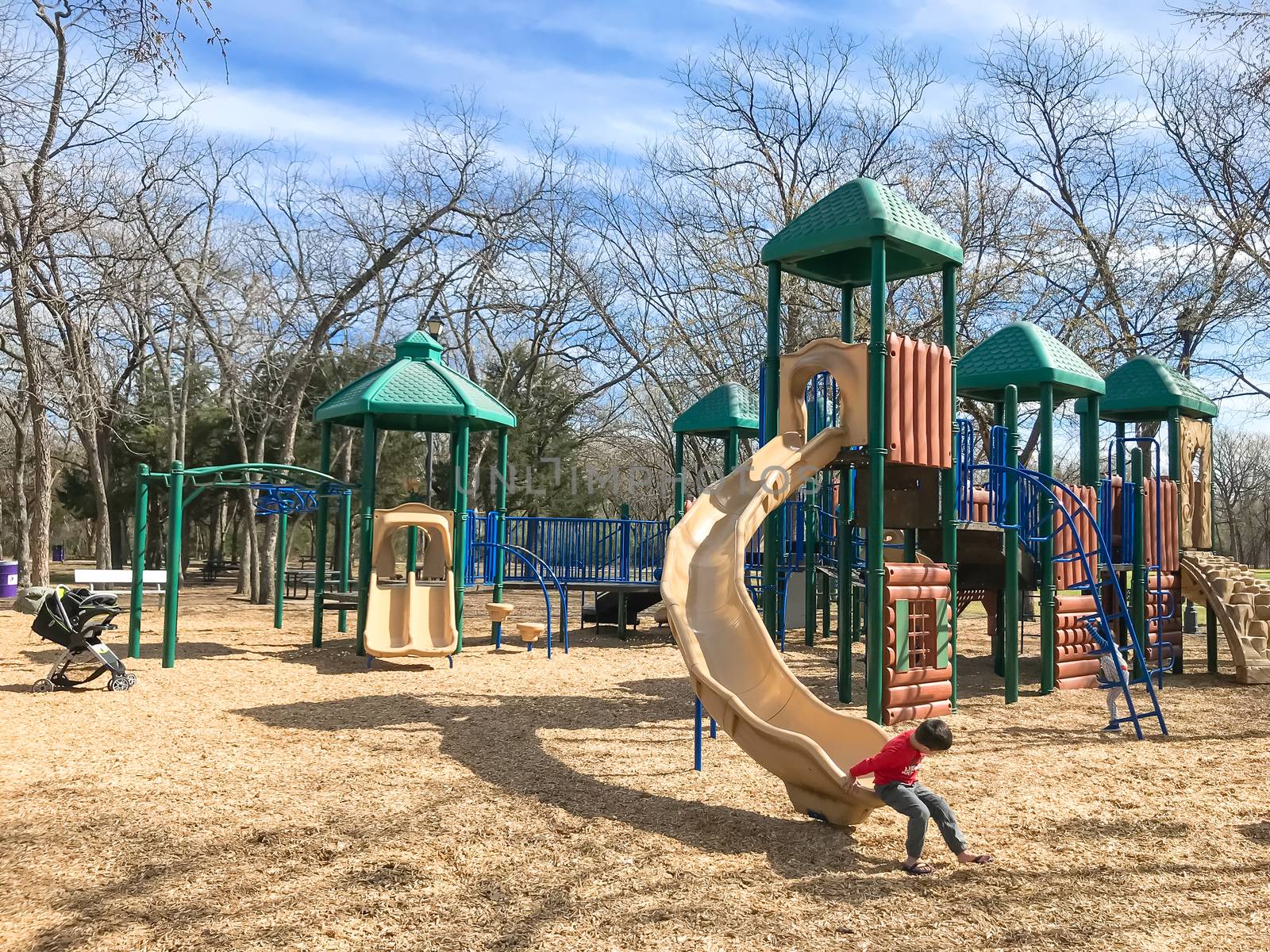 Outdoor playground with children playing wintertime in North Texas, America by trongnguyen