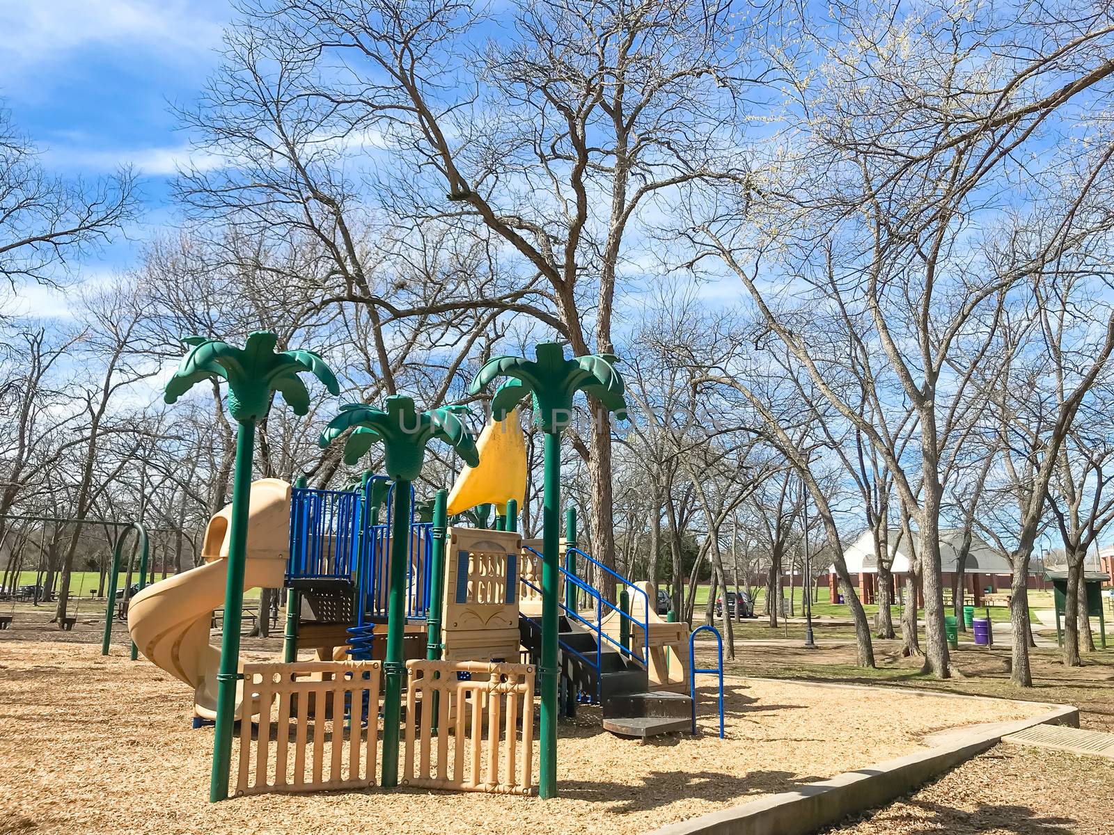 Outdoor playground surrounded by bare trees in wintertime in North Texas, America by trongnguyen