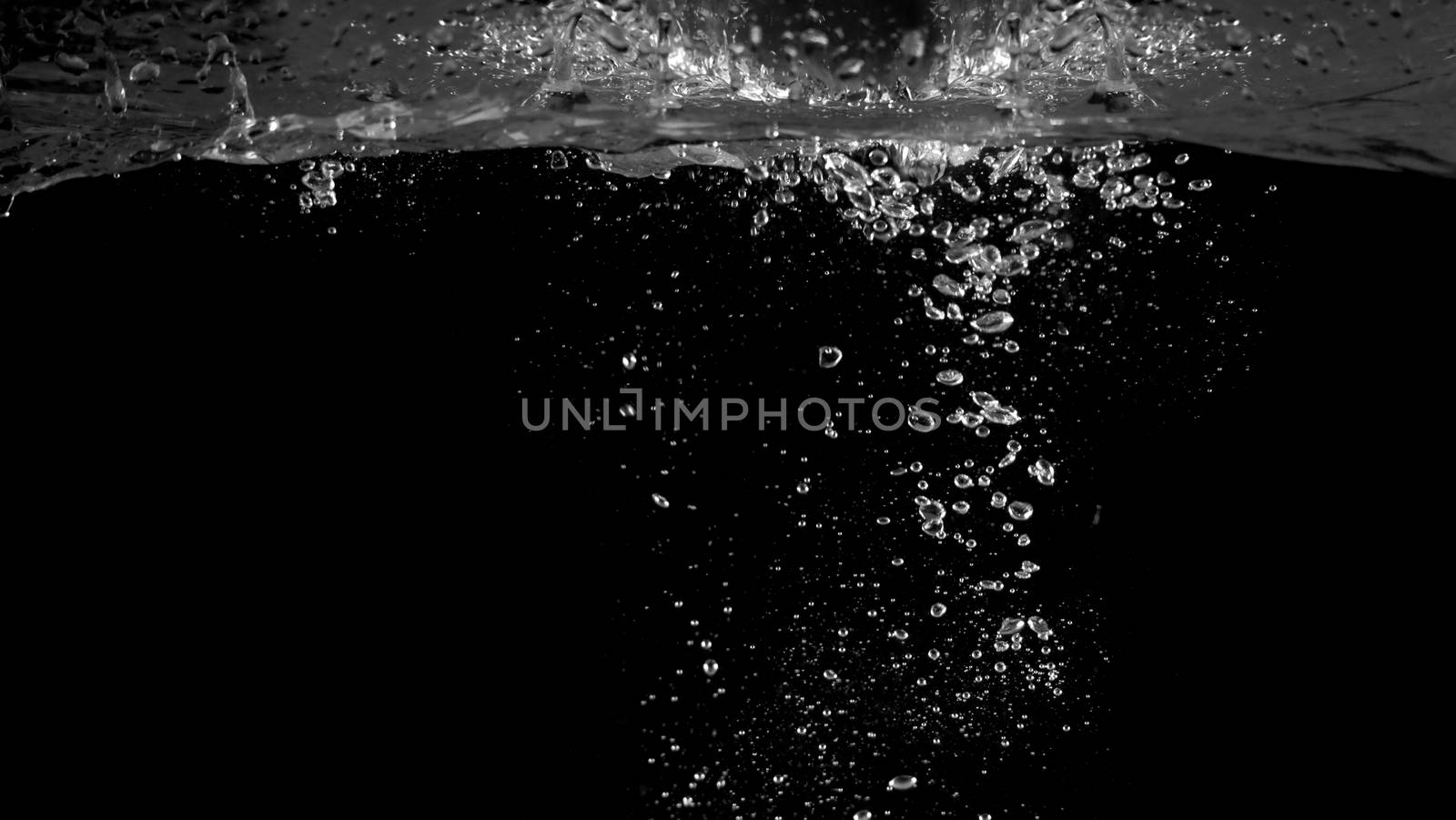 Blurry images of soda bubbles splashing in black background by gnepphoto