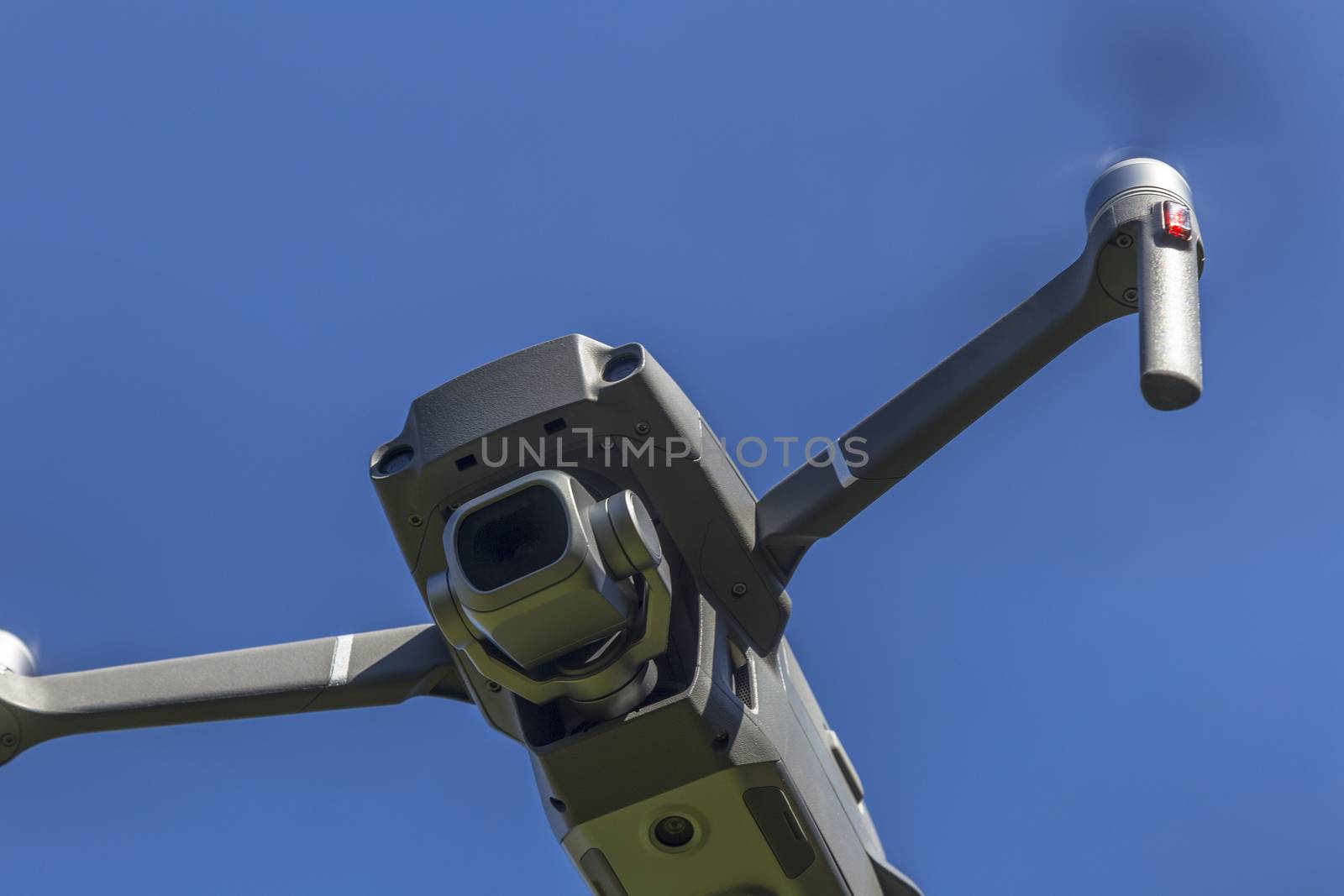 drone flying overhead against blue sky