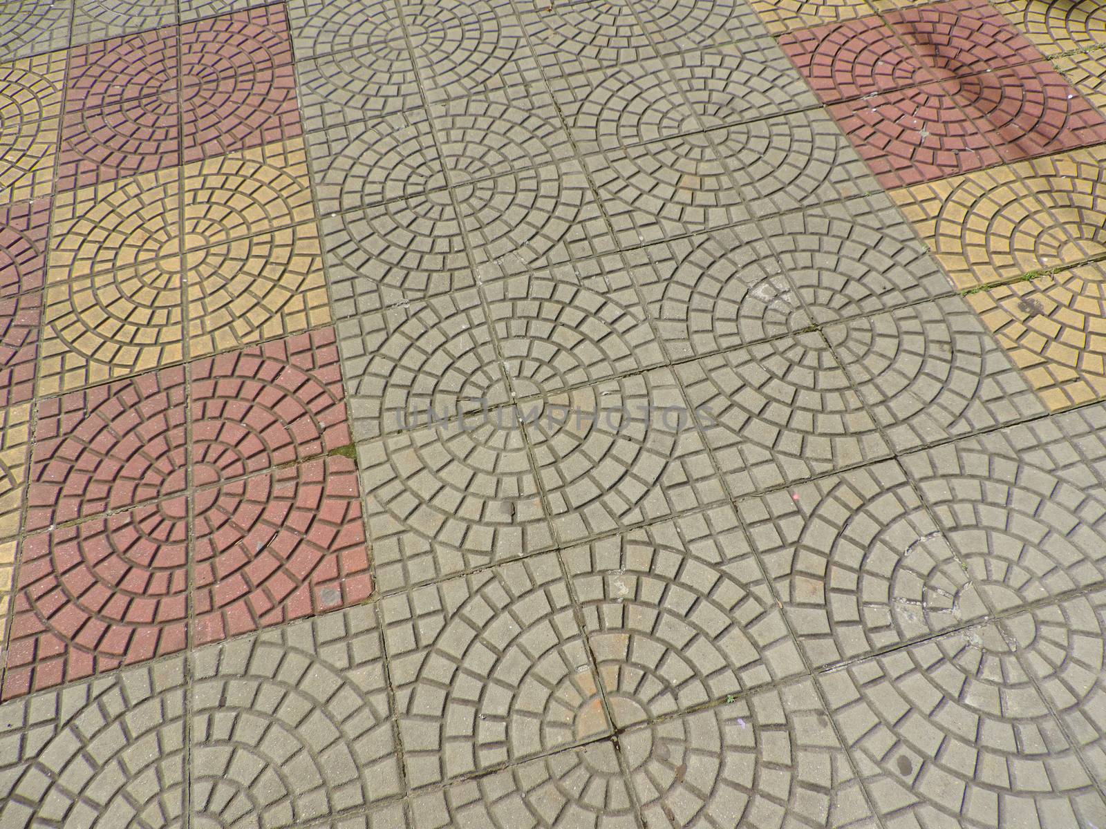 Tiled mosaic concrete pavement of the sidewalk