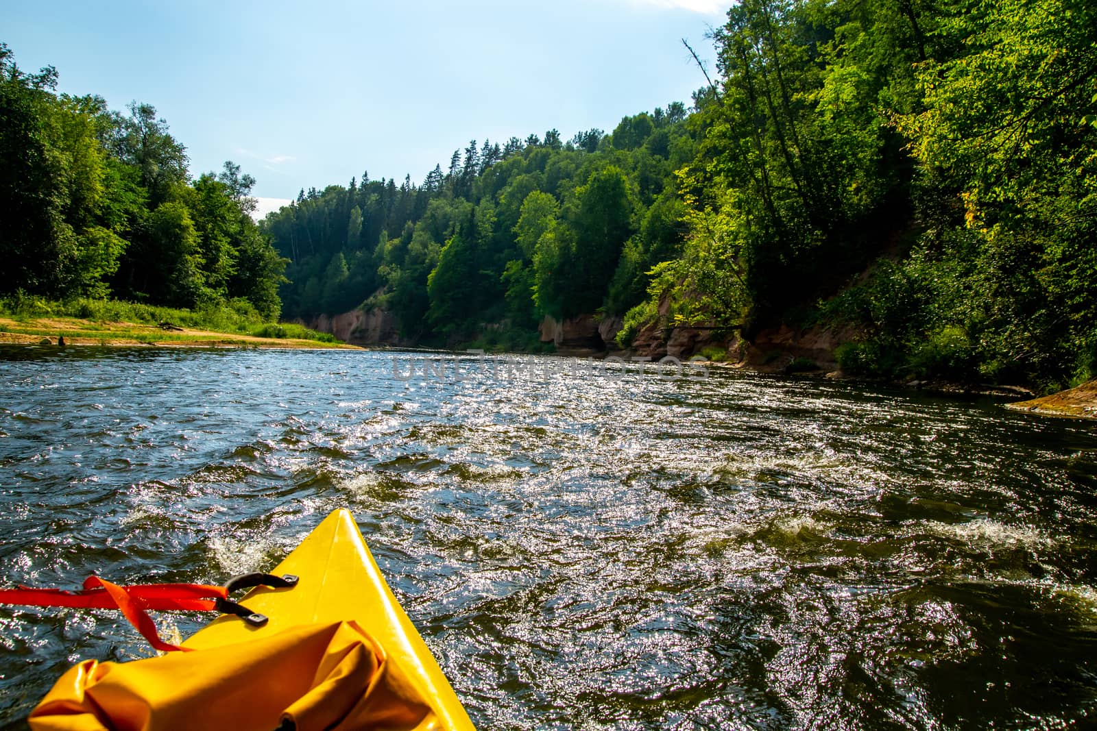 Kayak and canoe ride in river Gauja in Latvia. Boat ride by the river. Beautiful view of river from boat. The Gauja is the longest river in Latvia, which is located only in the territory of Latvia. Length - 452 km.

