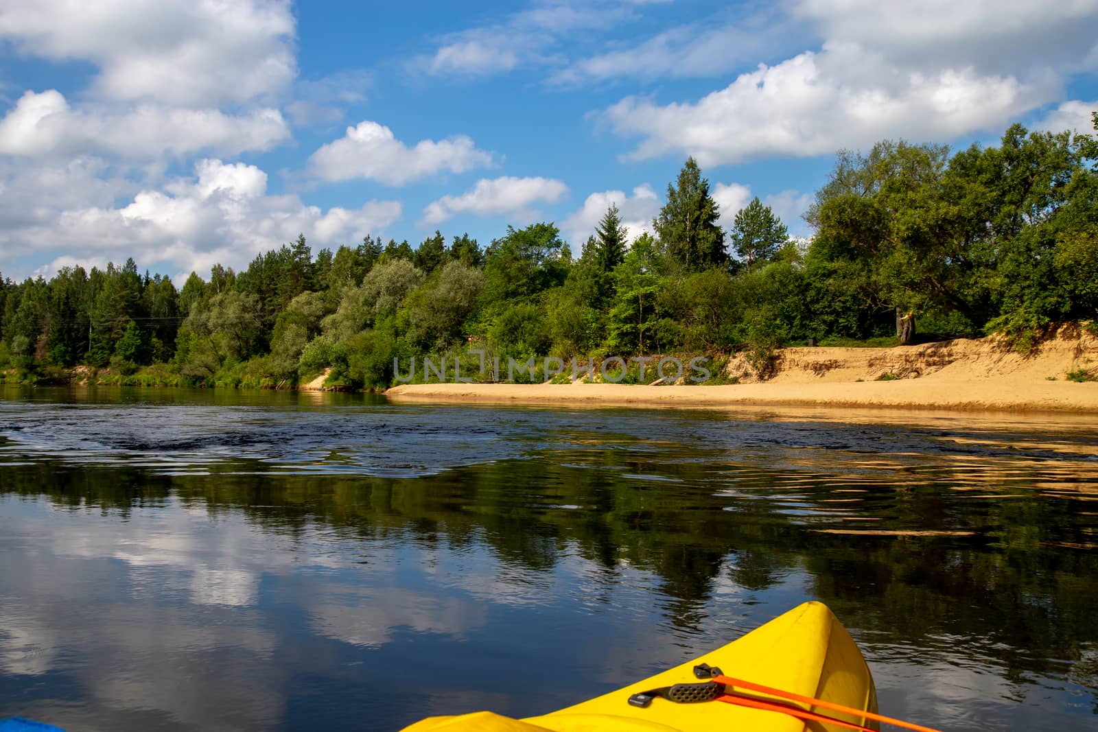 Kayak and canoe ride in river Gauja in Latvia. Boat ride by the river. Beautiful view of river from boat. The Gauja is the longest river in Latvia, which is located only in the territory of Latvia. Length - 452 km.

