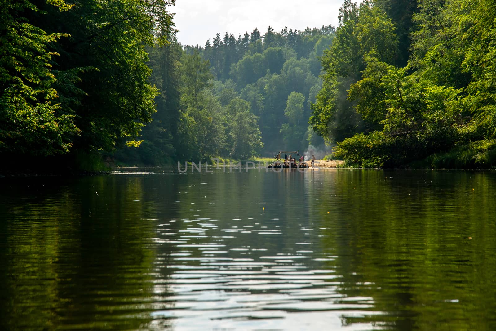 People boating on river Gauja in Latvia, peacefull nature scene. By raft through the river. Raft trip along the Gauja River in Latvia. The Gauja is the longest river in Latvia, which is located only in the territory of Latvia. Length - 452 km.



