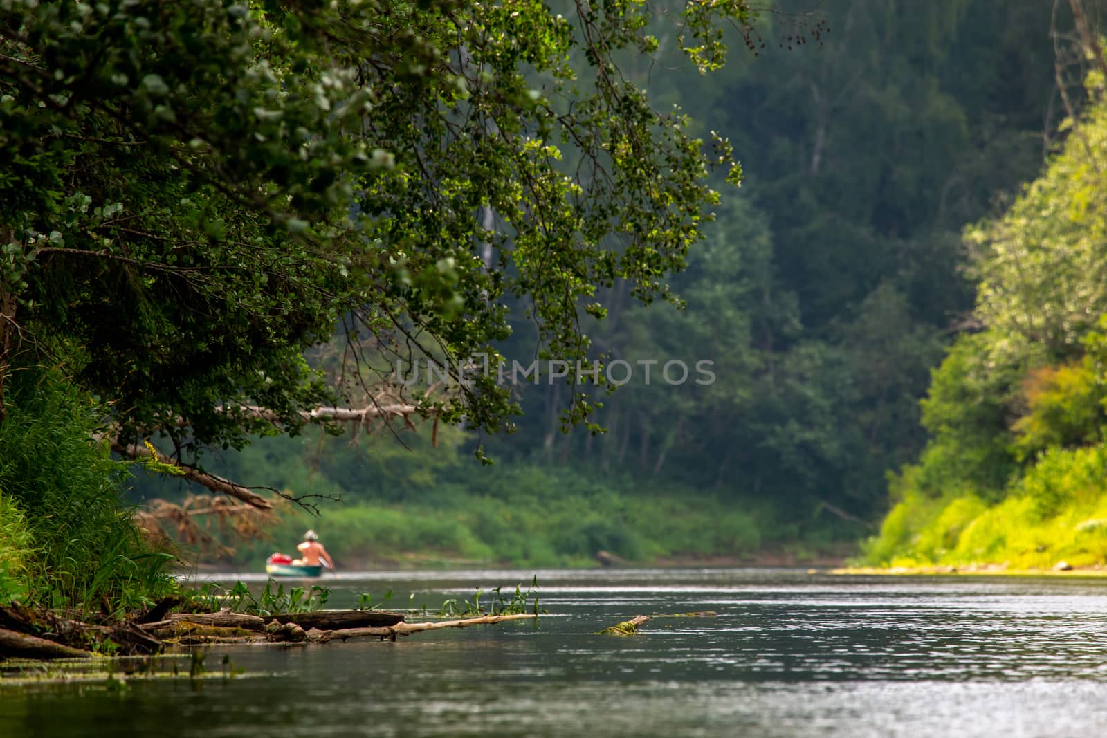 People boating on river Gauja in Latvia, peacefull nature scene. By boat through the river. Boat trip along the Gauja River in Latvia. The Gauja is the longest river in Latvia, which is located only in the territory of Latvia. Length - 452 km.



