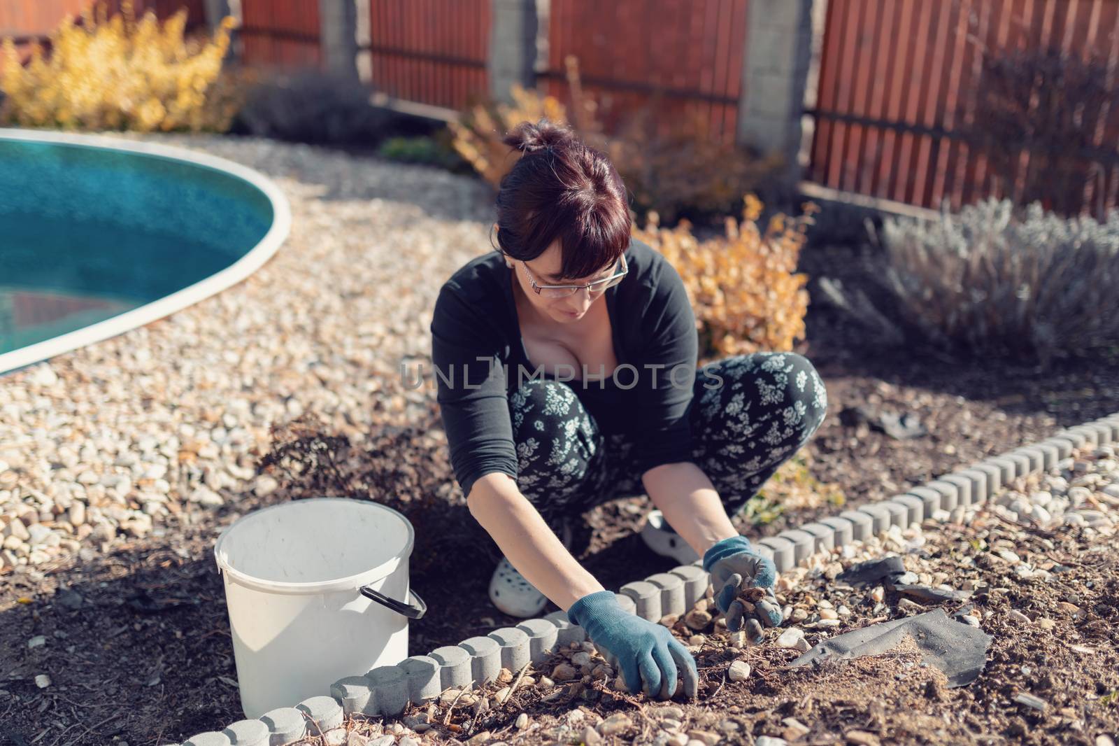 middle age woman gardener in spring garden by artush