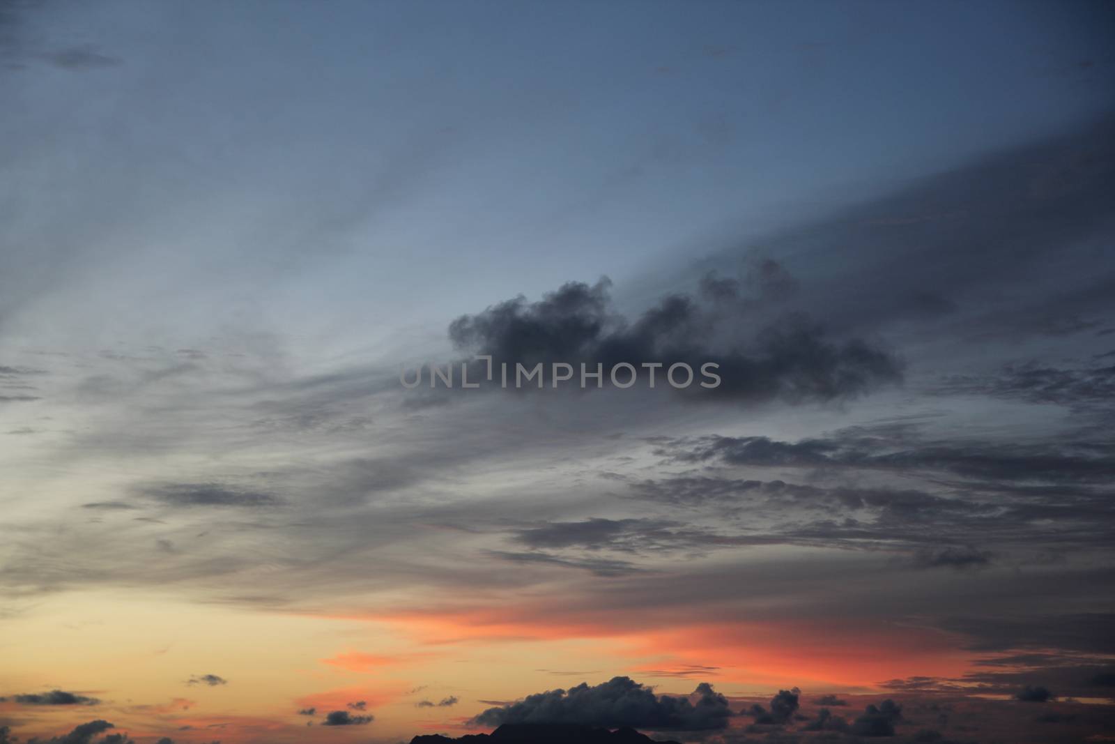 uninhabited island in the ocean against the sunset