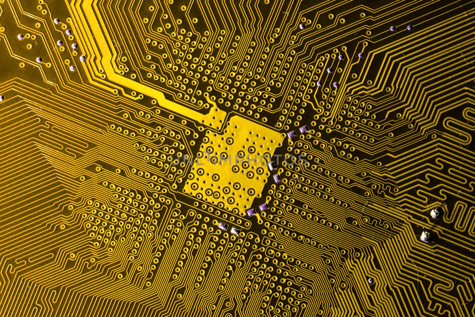 Close up photo of yellow printecd circuit board with solder points