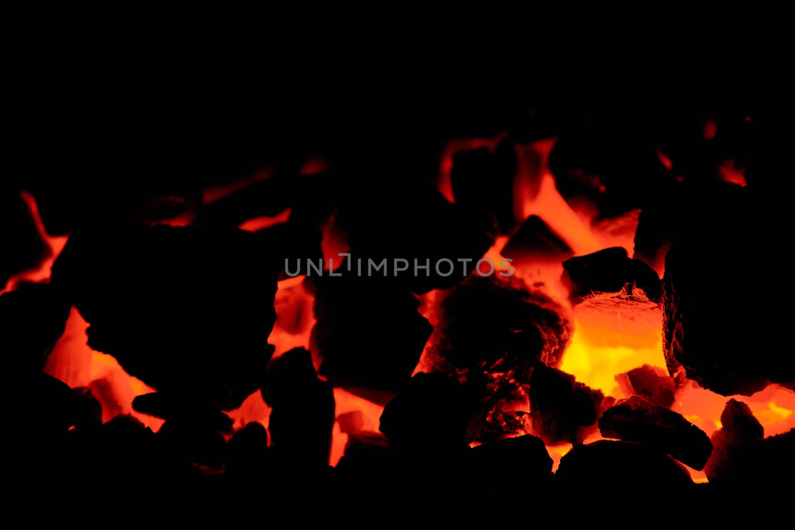 Coal anthracite. Burning coal in the furnace of a solid fuel boiler. Heat. Flame. Forge furnace. Hot coal. Burning solid fuel.