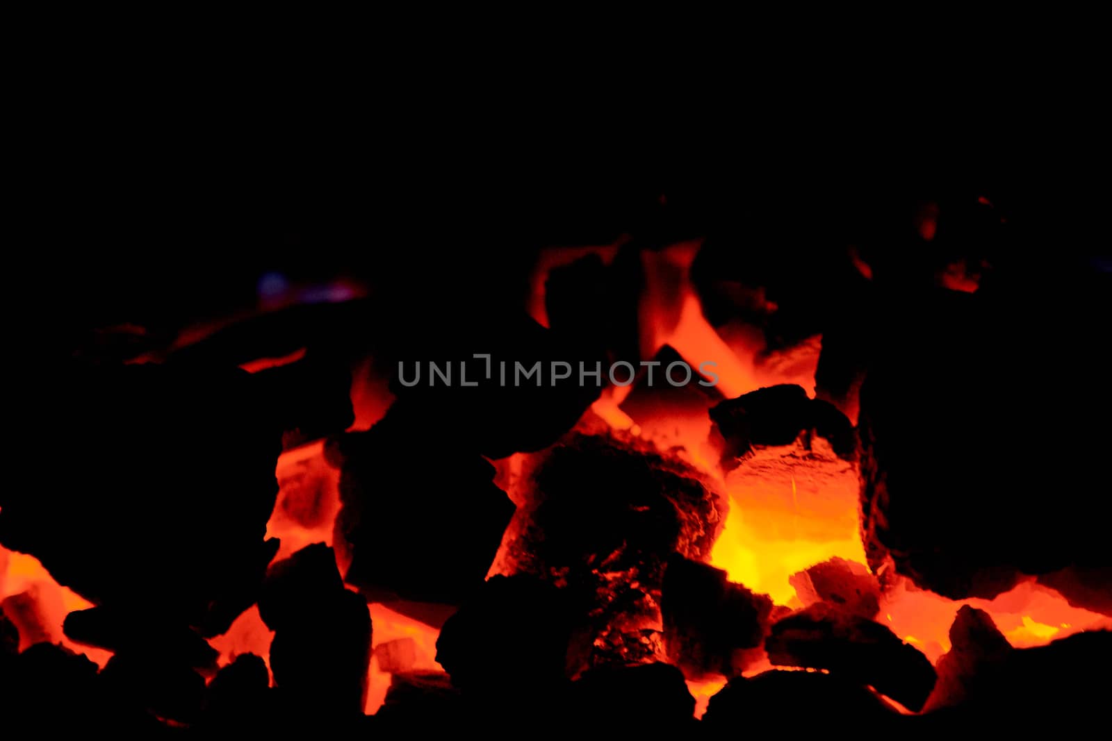 Coal anthracite. Burning coal in the furnace of a solid fuel boiler. Heat. Flame. Forge furnace. Hot coal. Burning solid fuel.
