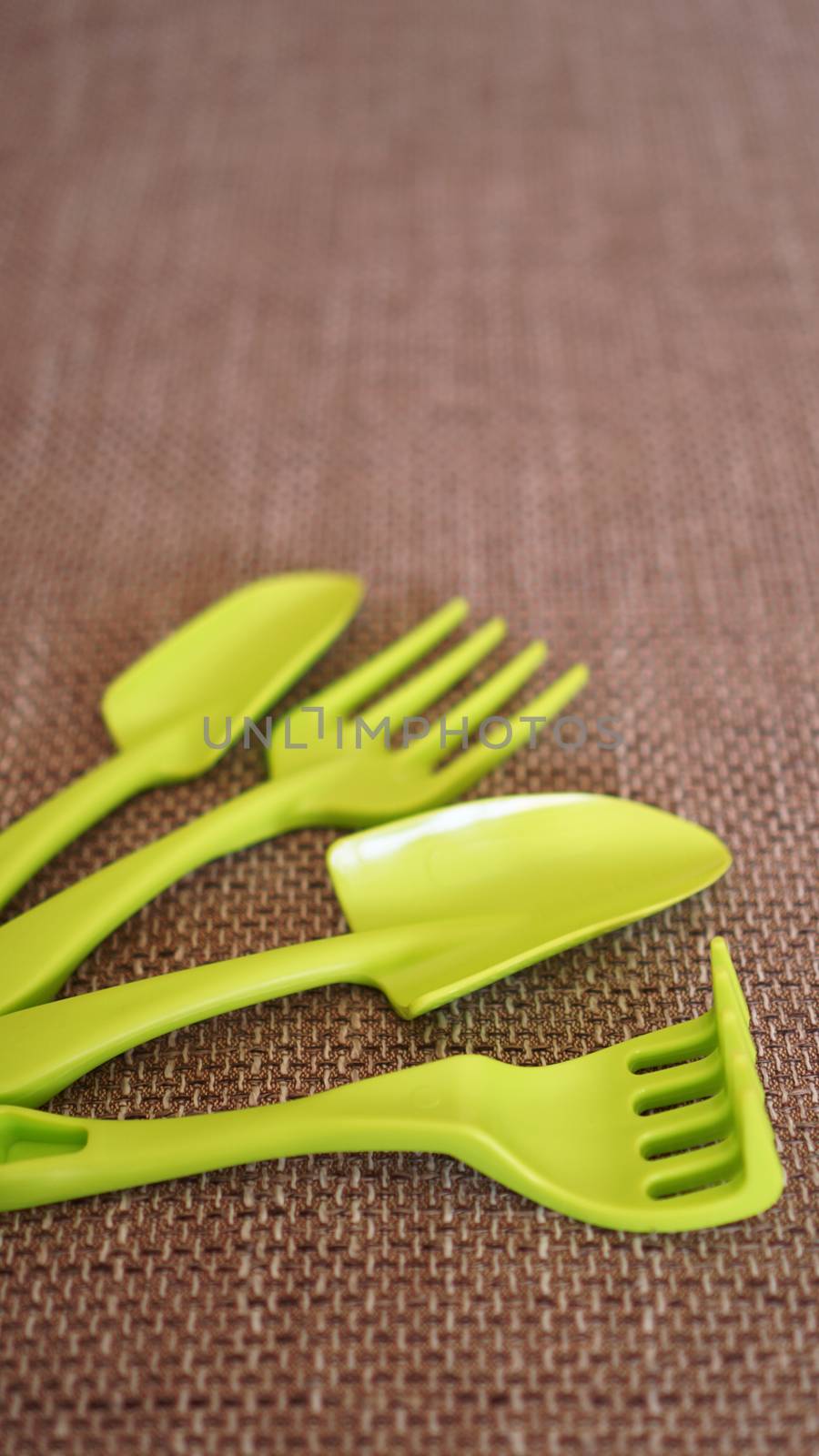 Gardening background. Gardening green tools and flowers - soft focus - vertical format