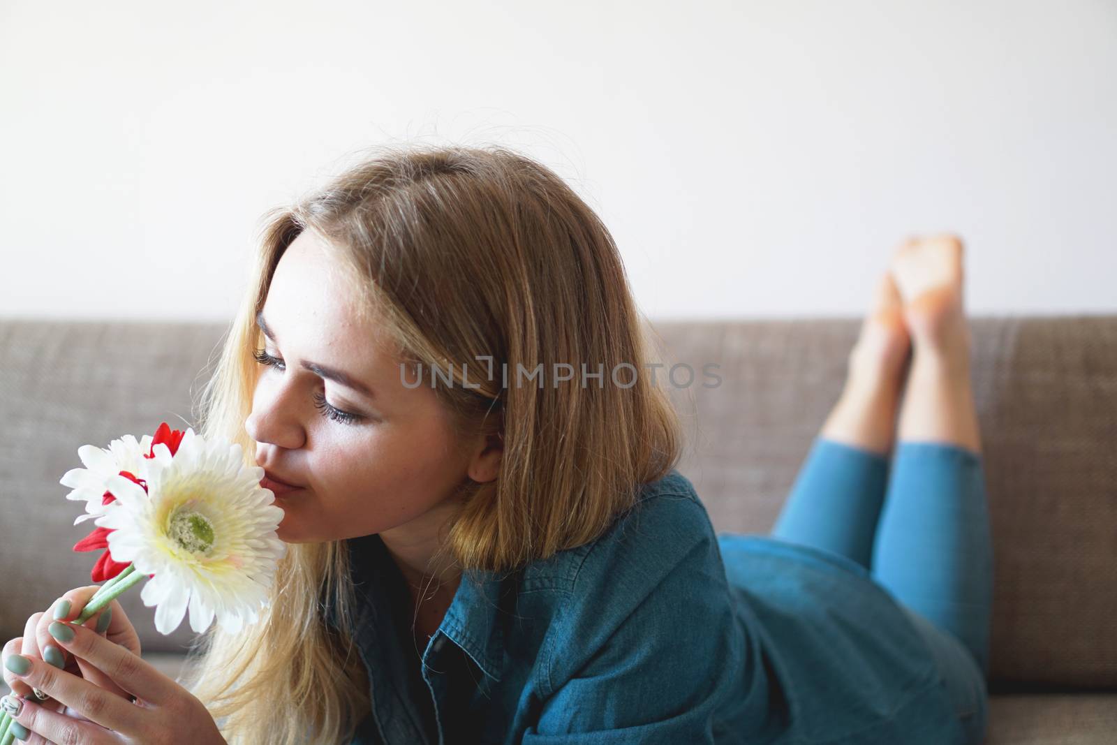 Attractive young woman sniffing bouquet of flowers by natali_brill