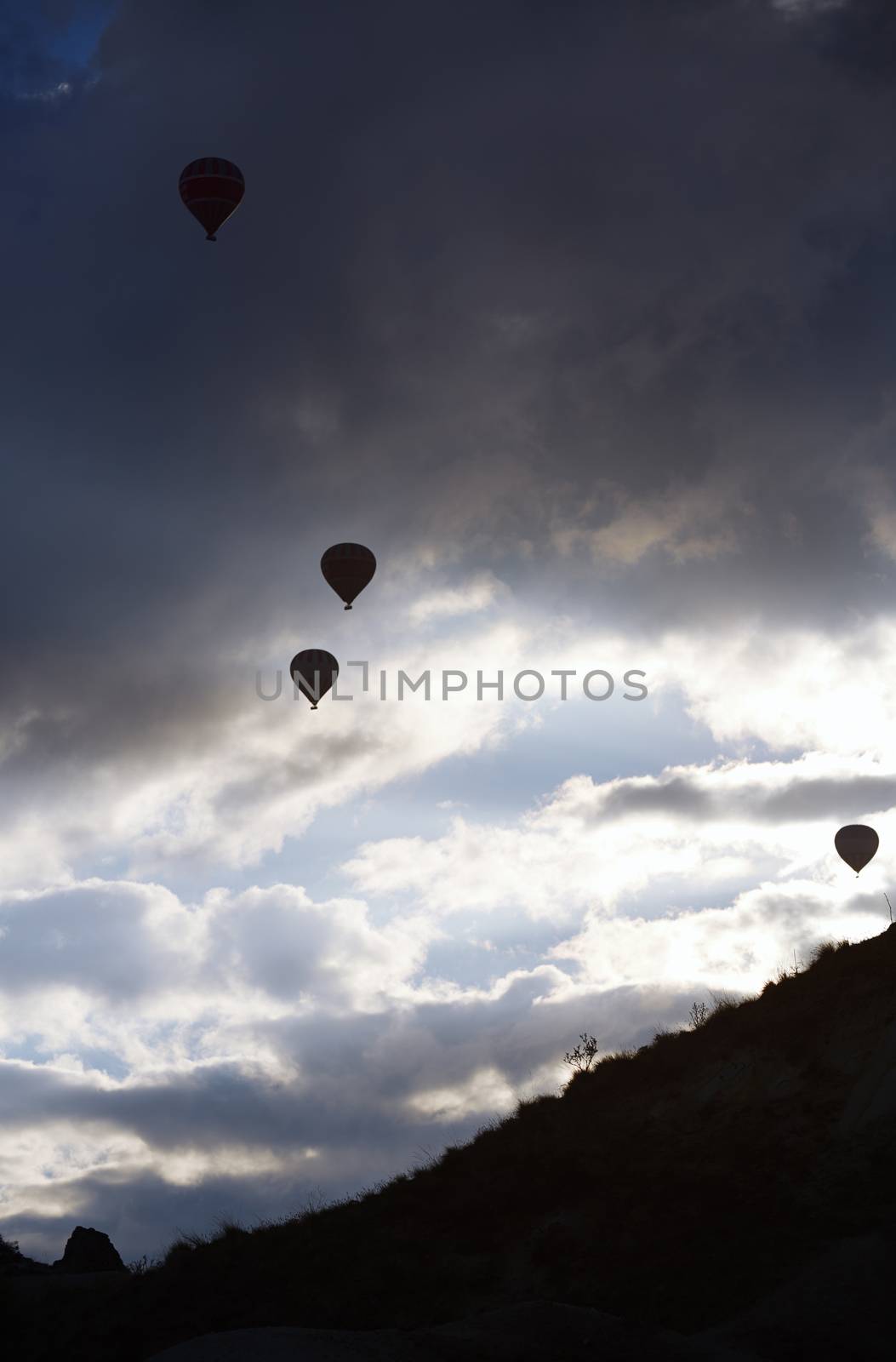 Silhouettes of the hot air balloons flying by Novic