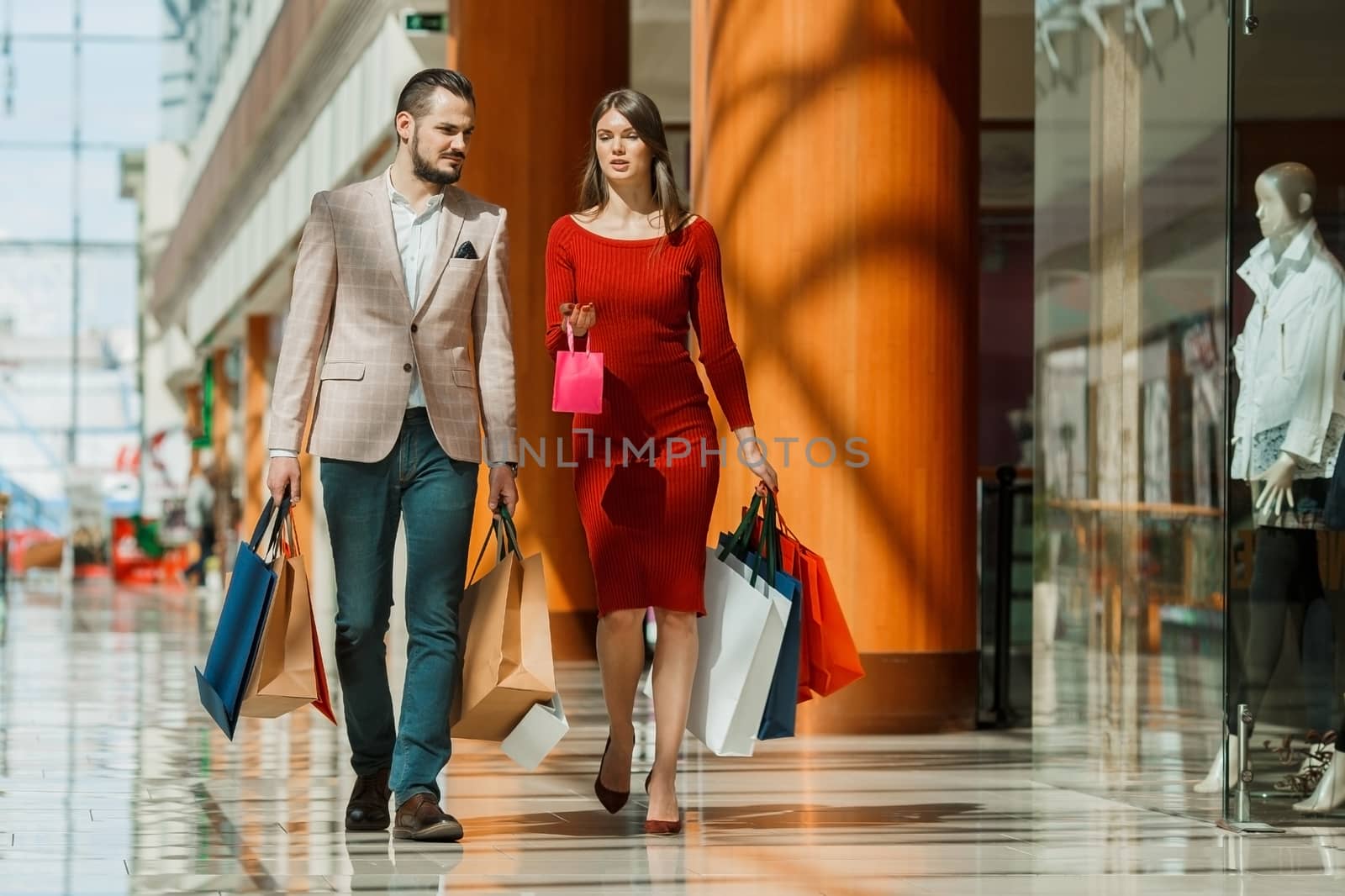 Young couple with shopping bags by ALotOfPeople