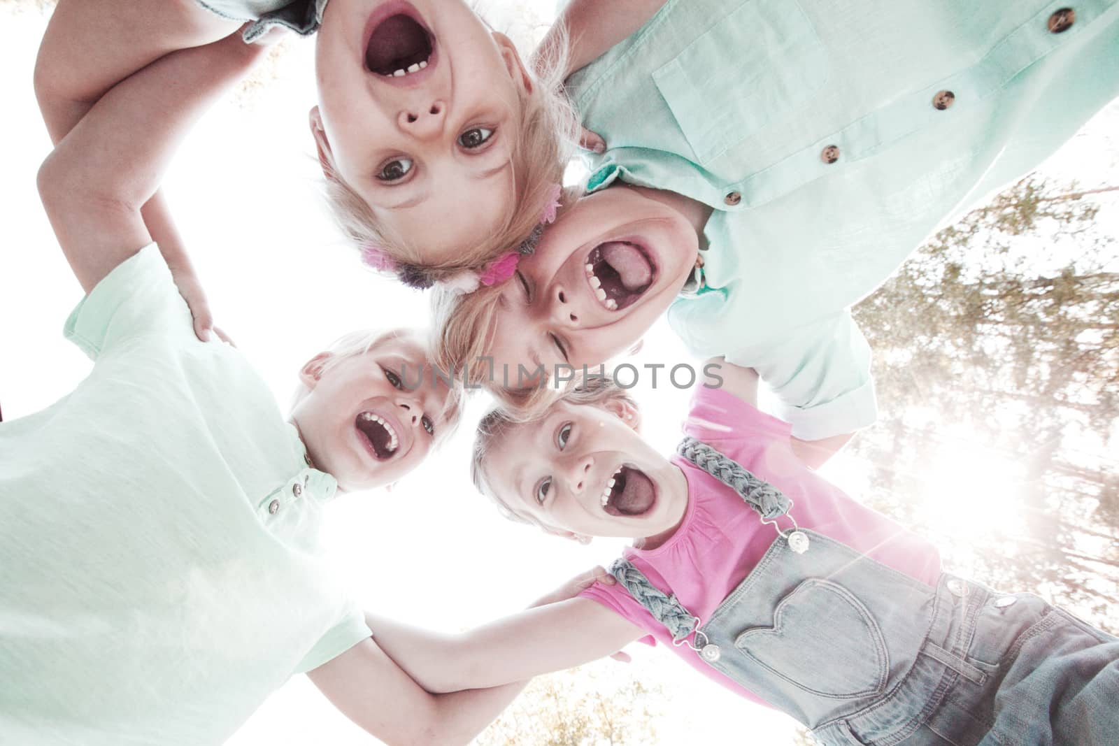 Group of smiling children looking down into camera