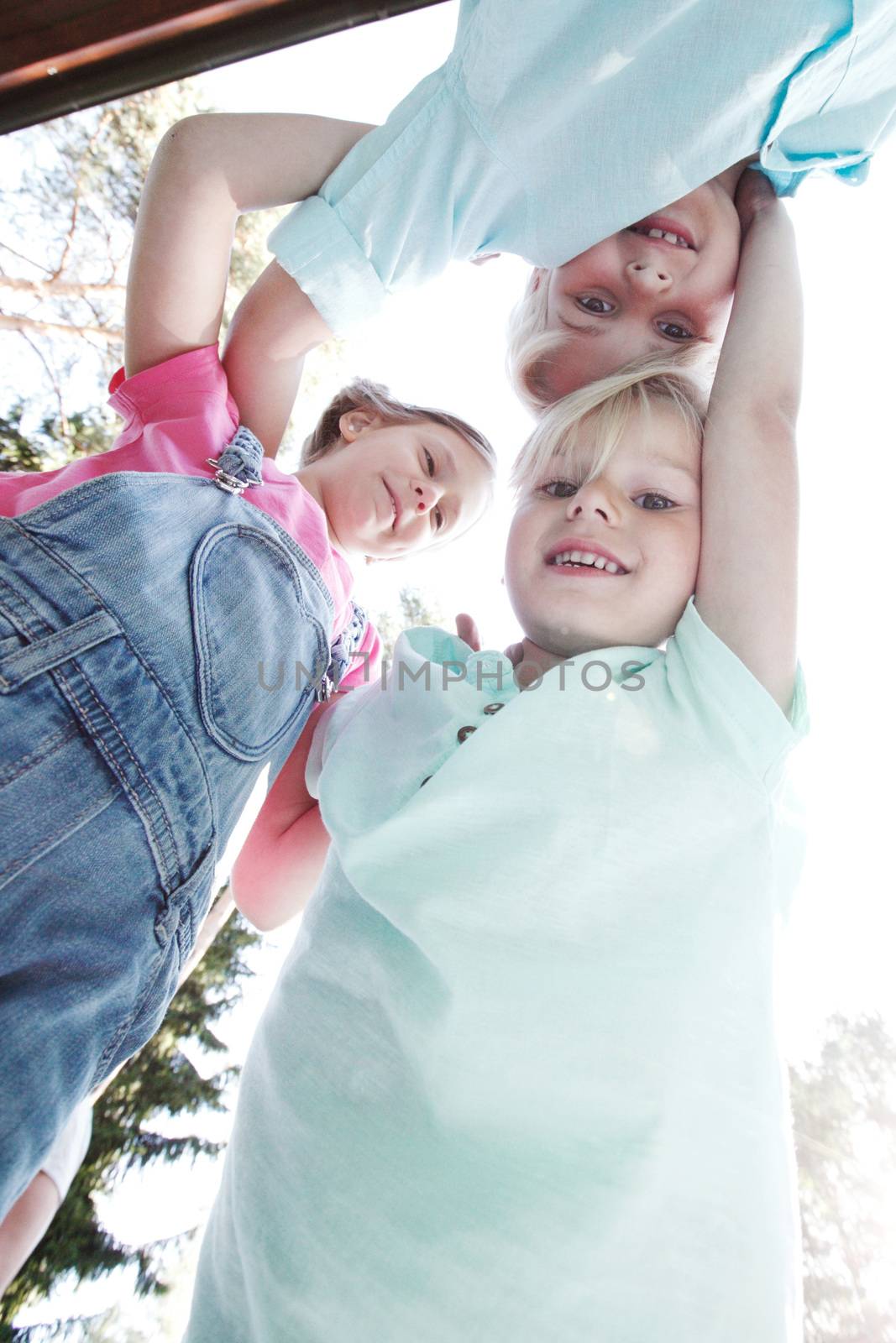 Group of smiling children looking down into camera