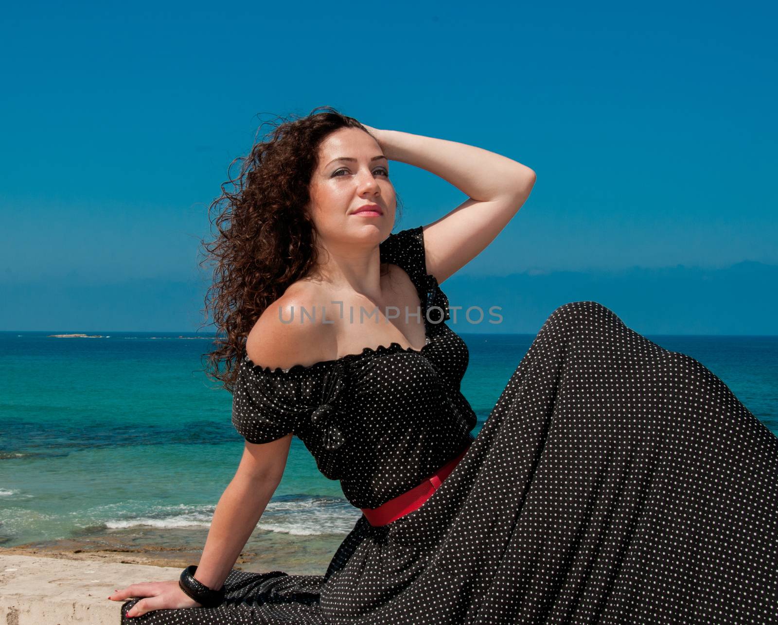 The girl in a black dress sitting on the beach by ben44