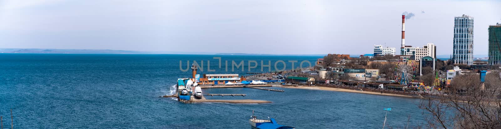 Vladivostok, Russia - 24 March, 2019: View of the city embankment and amusement park by rdv27