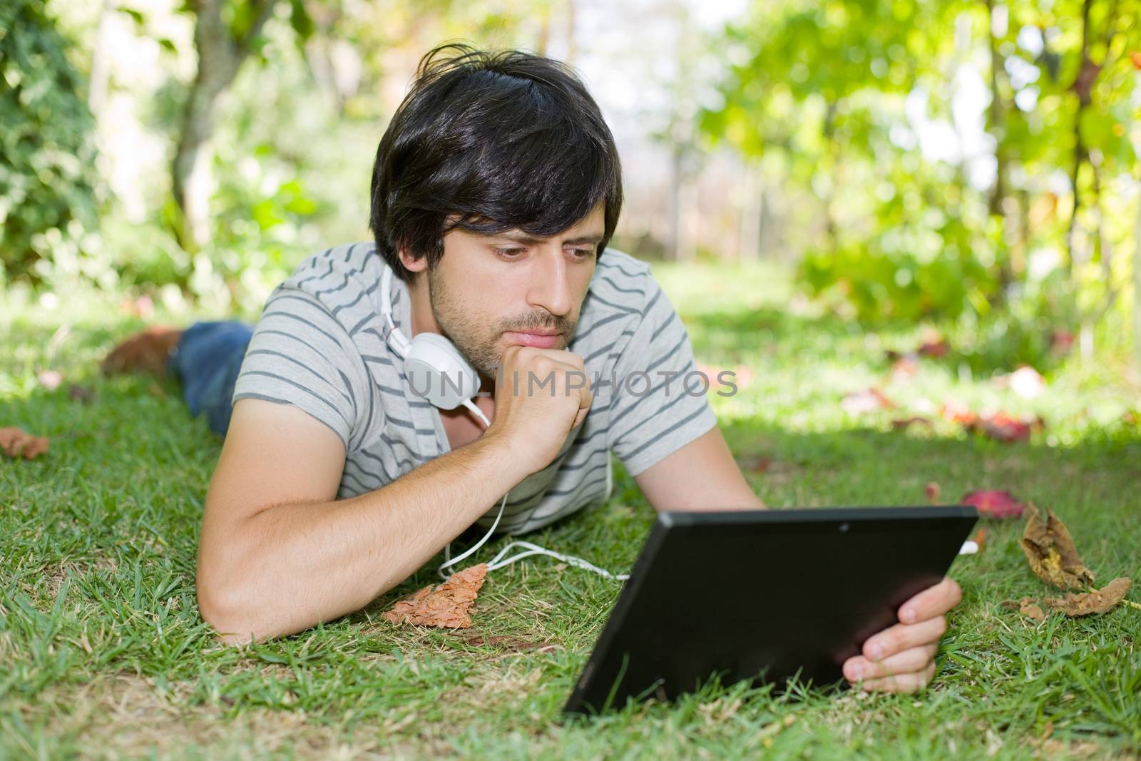 man relaxing with tablet pc by zittto