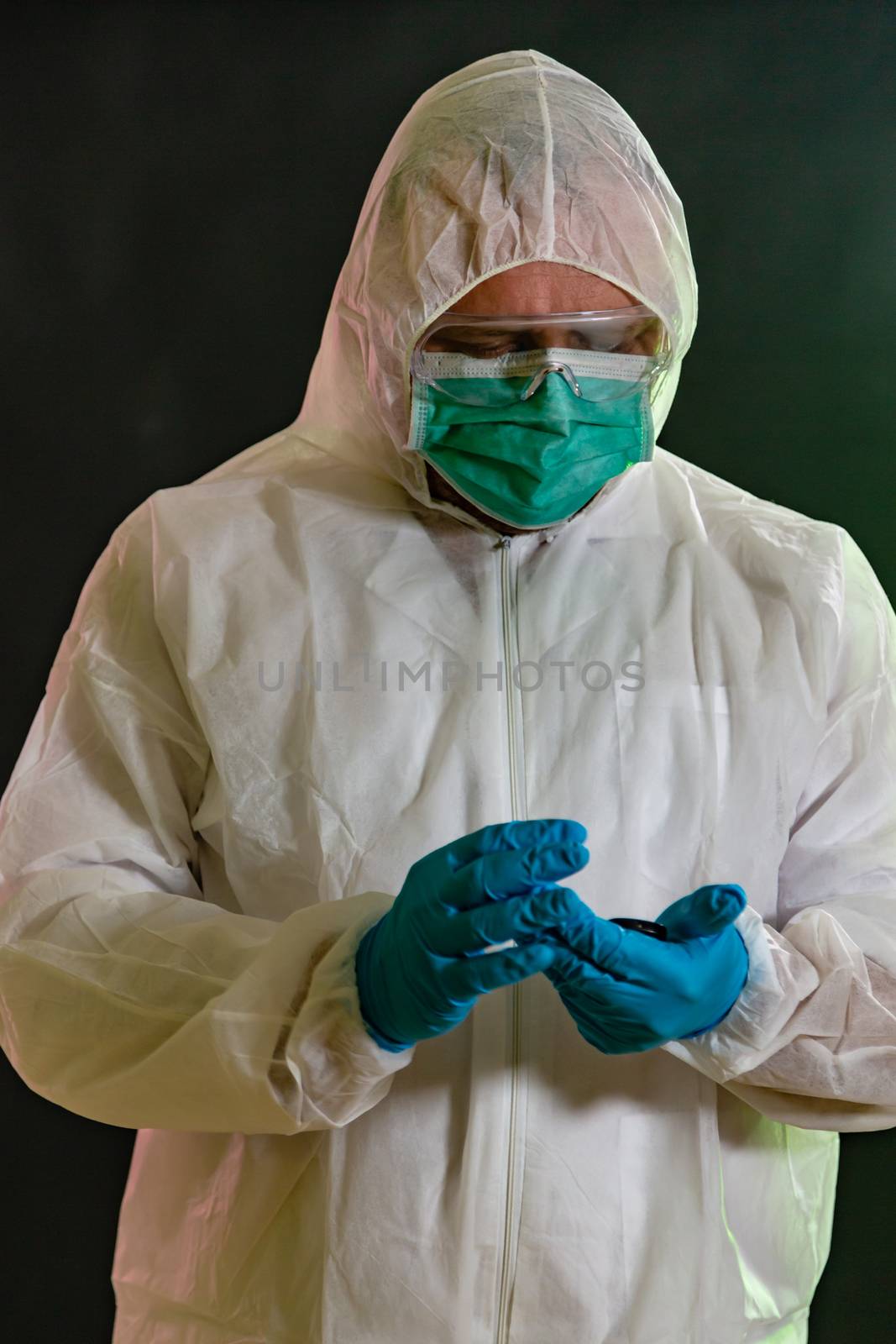 Man in chemical suit measures toxicity levels and checks for contamination