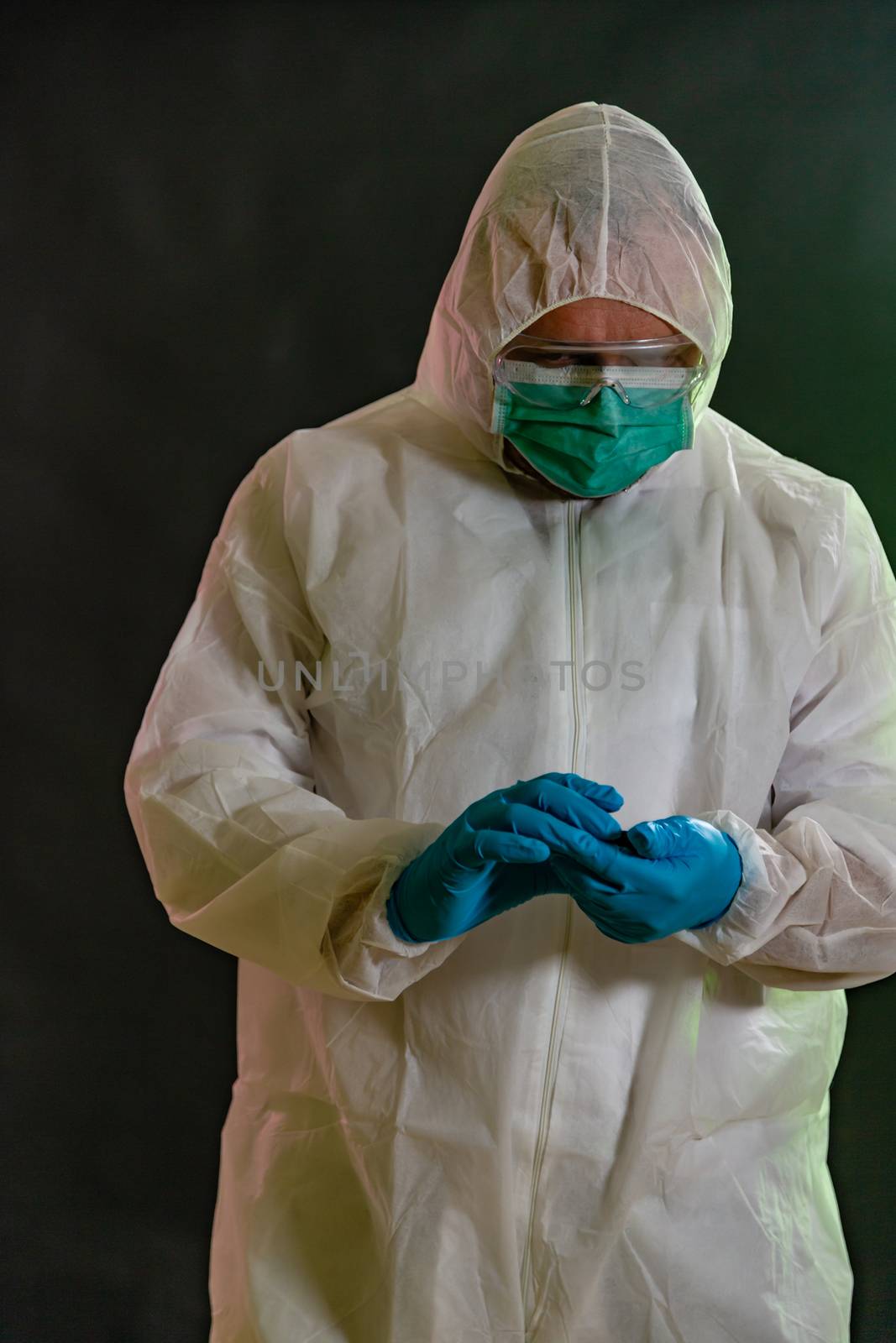 Man in chemical suit measures toxicity levels and checks for contamination