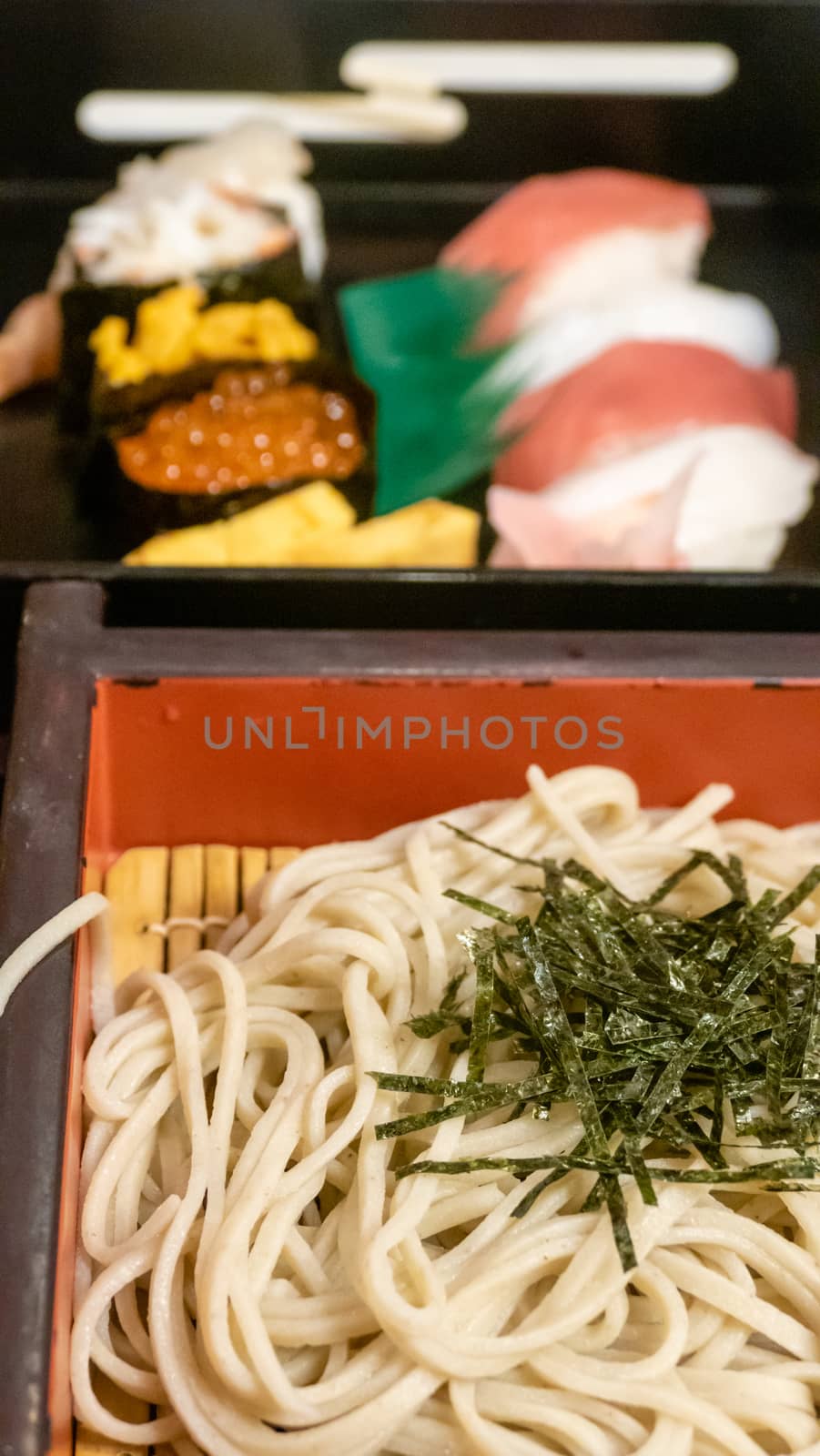 Japanese soba noodles, sashimi and nori-wrap sushi platter