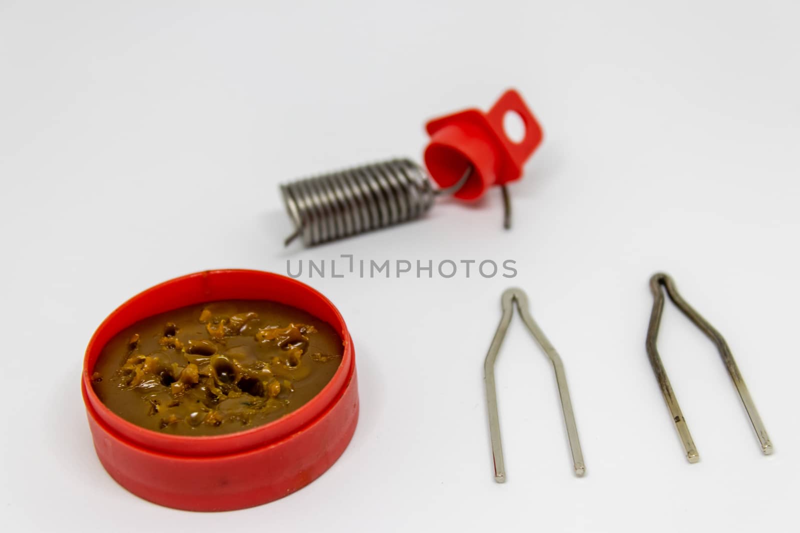 coil spring and grease oil closeup shoot with white background. photo has taken as product photo focus on grease.