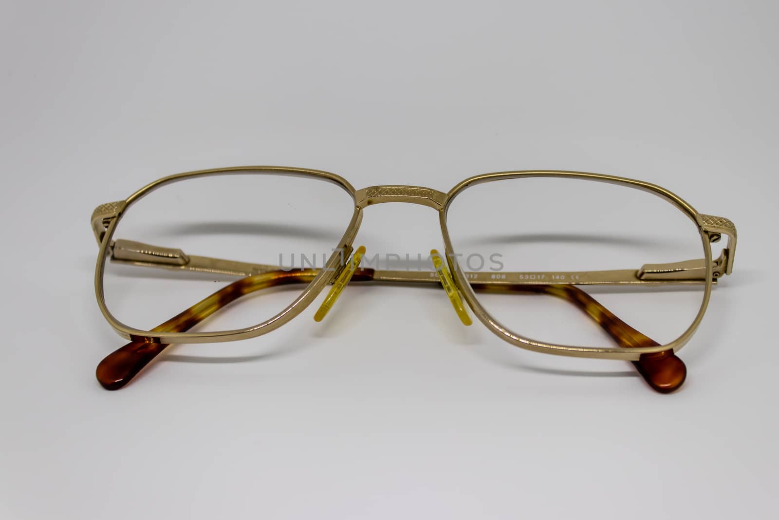 old glasses closeup with gold frame by Swonie