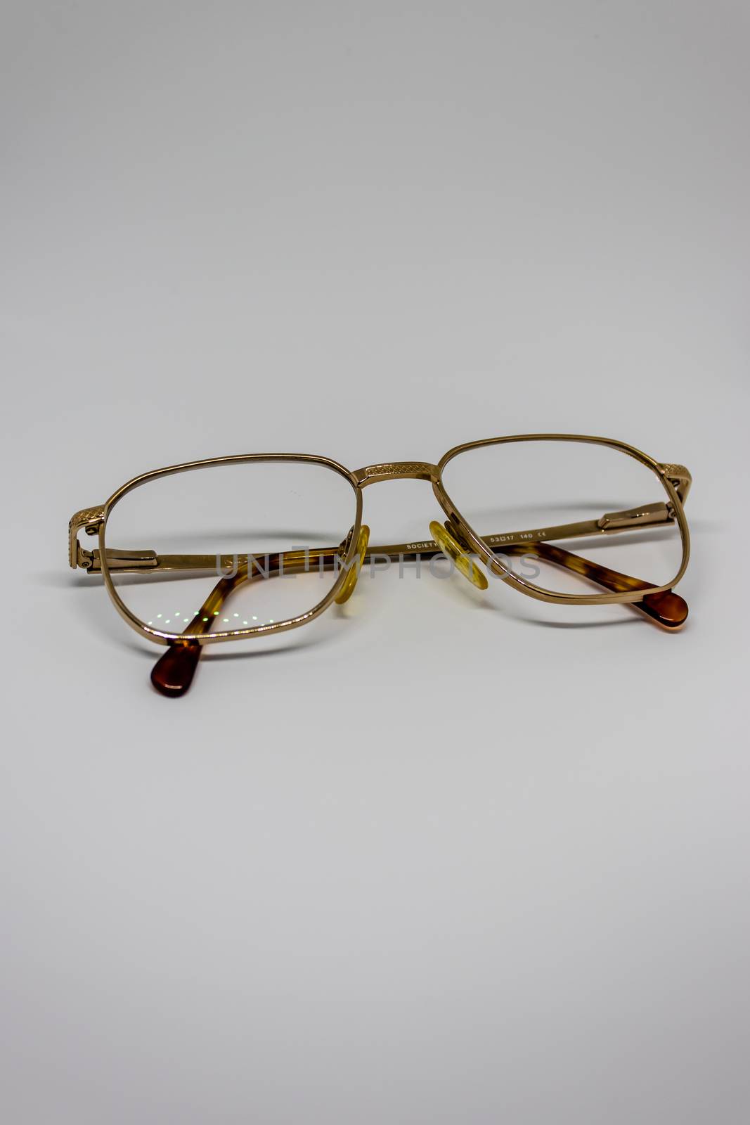 old glasses closeup with white background as product photo. with gold frames.