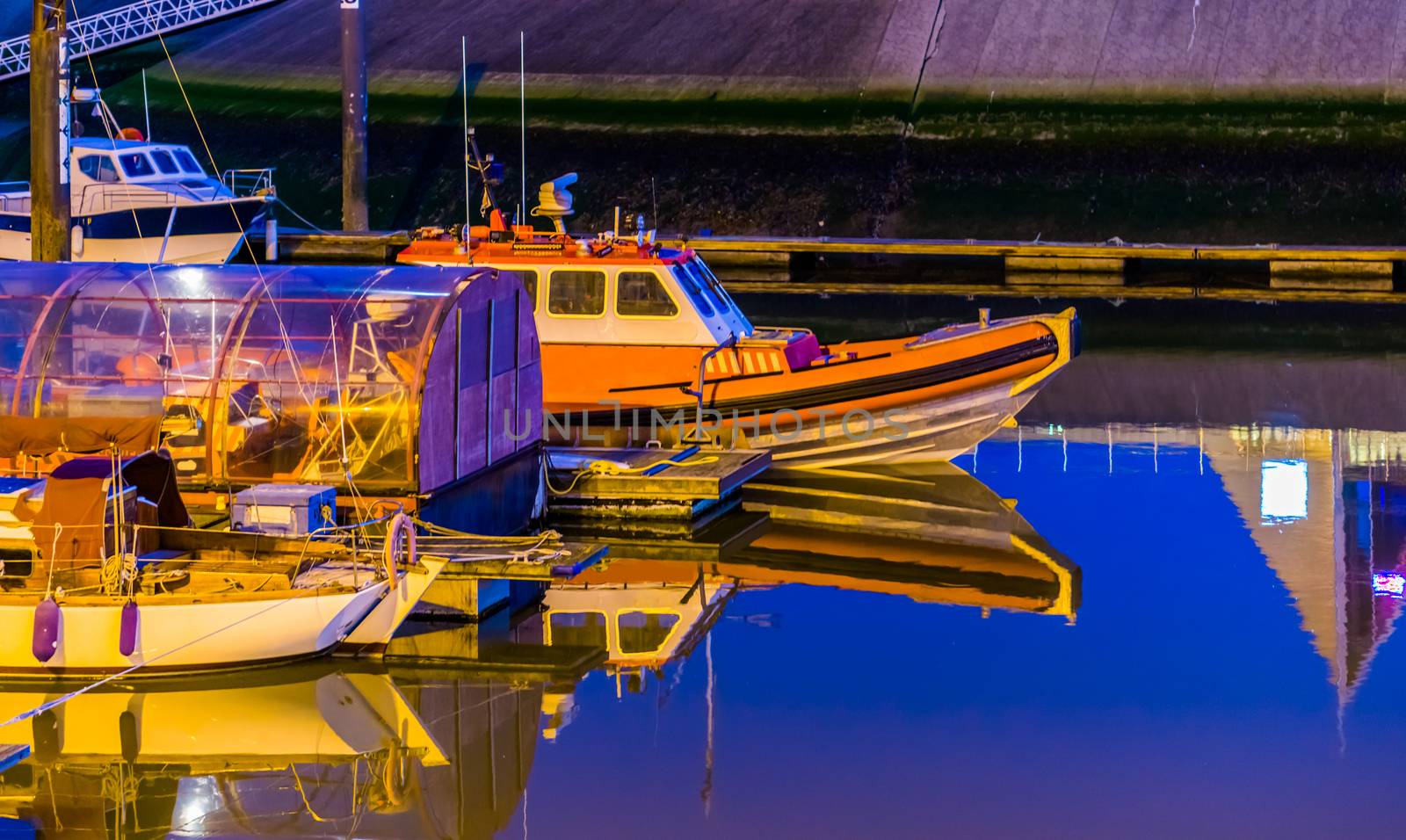 Boats docked in the harbor of Blankenberge at night, Belgium city architecture, water transportation