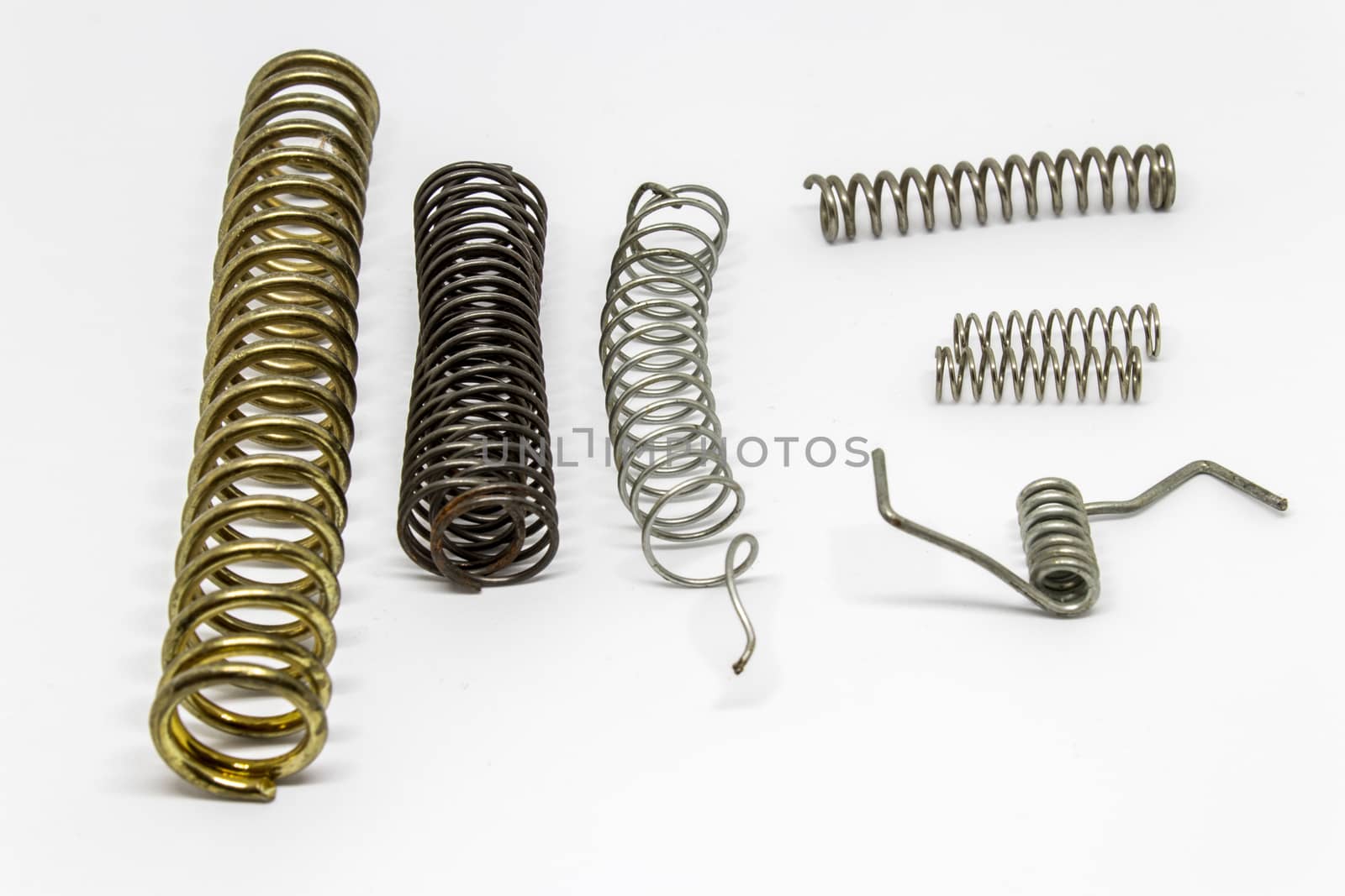 some scraps with white background. there is some different sized metal springs.