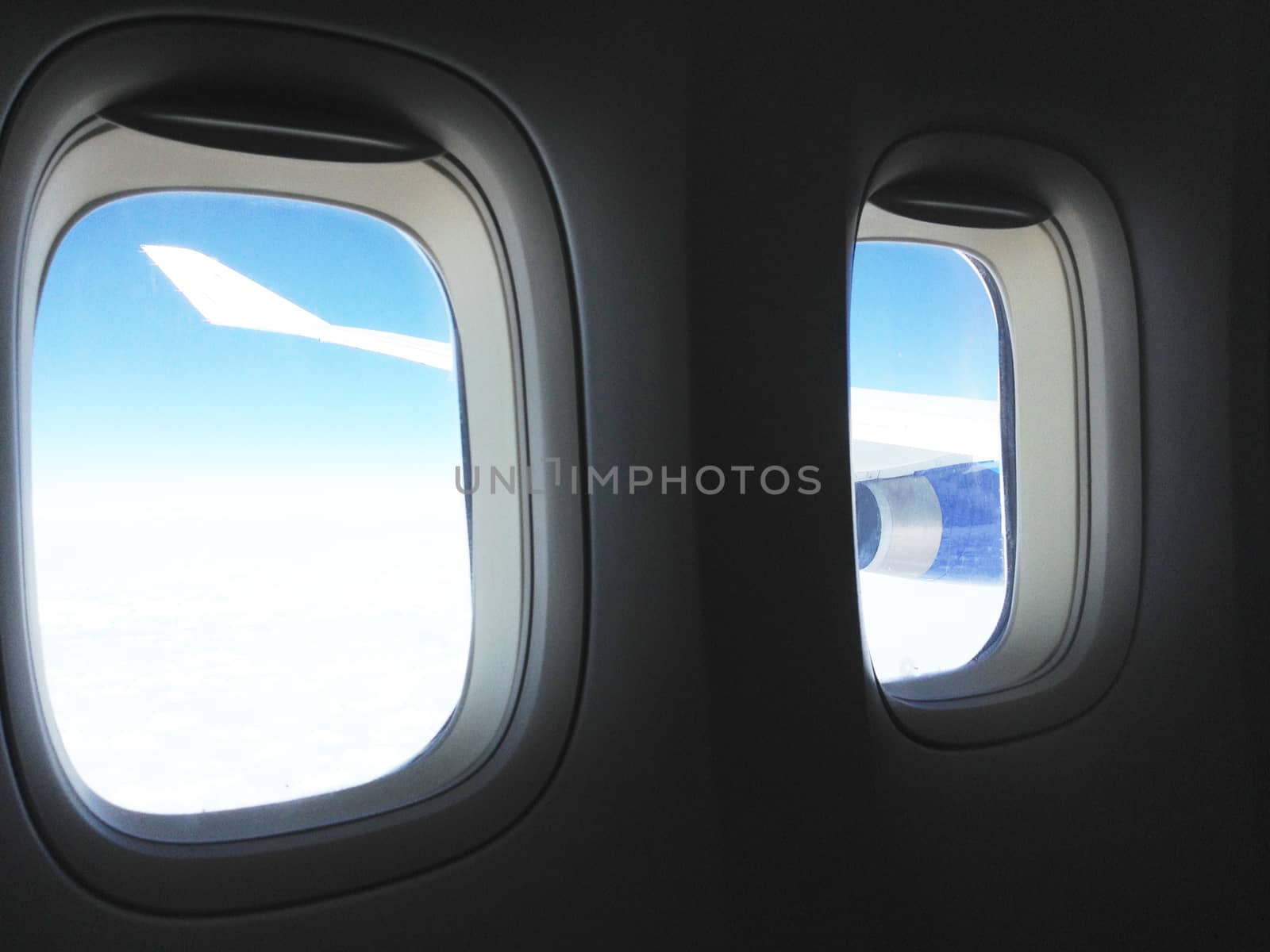 The view from the airplane on the wing, flying over the clouds. The concept of traveling by plane.