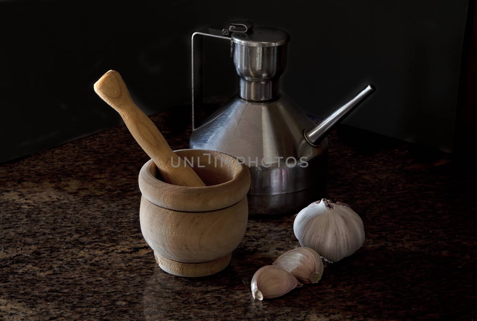 Ingredients of garlic sauce, vintage color, steel jug with olive oil, garlic head, garlic cloves, mortar and pestle