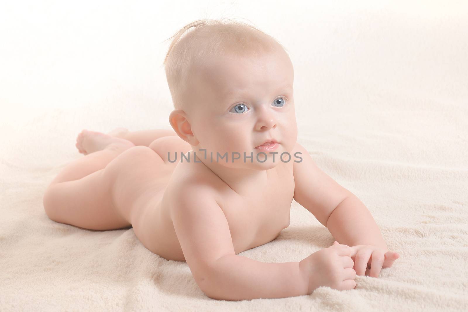 Newborn Infant awake newborn girl with blue eyes laying on blanket