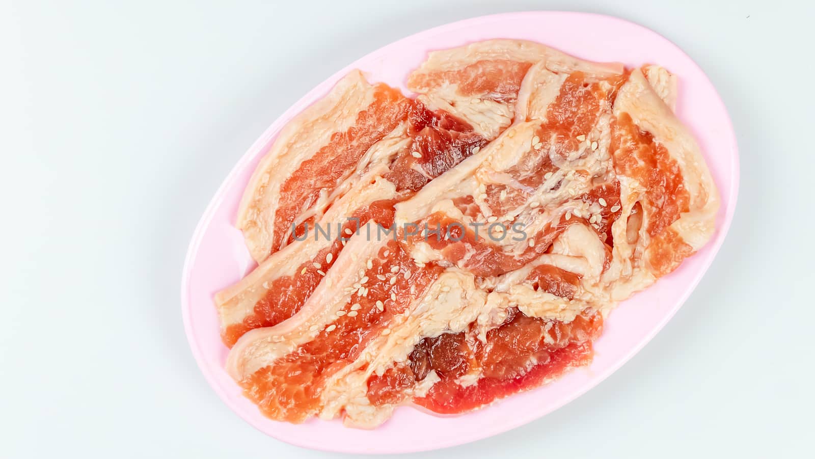 top view raw pork on plate  over white background