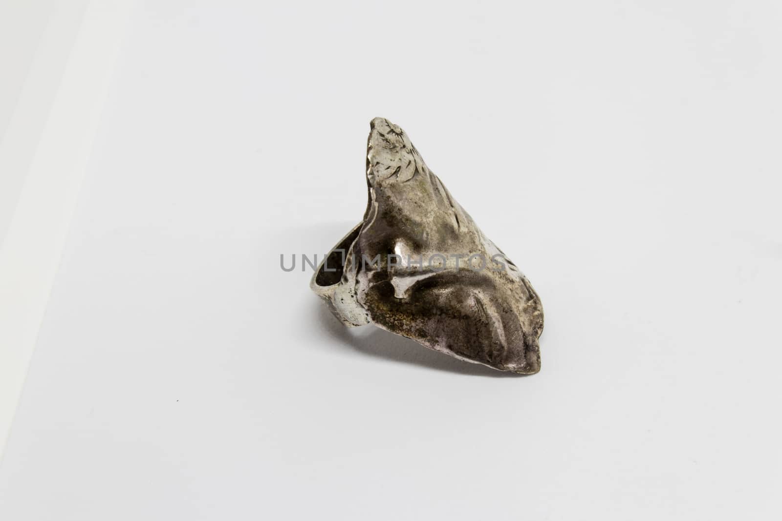 an old silver ring closeup shoot with white background. this object photo got sharp details.