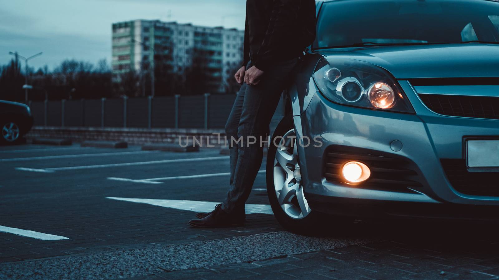 Close up of modern sedan headlamp. Front view shot from side of vehicle. Car headlight background.