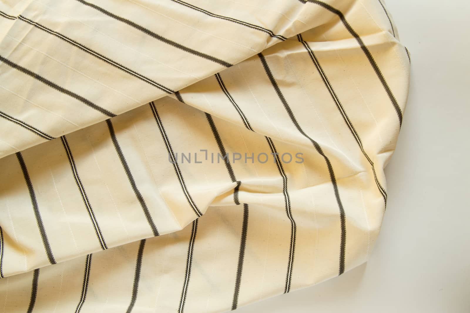 Beige linen fabric with black stripes, the texture of the fabric, the weaving industry or material for sewing