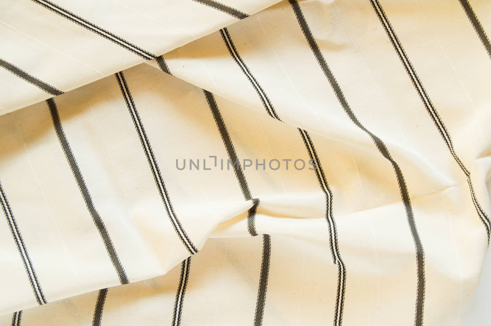 Beige linen fabric with black stripes, the texture of the fabric, the weaving industry or material for sewing