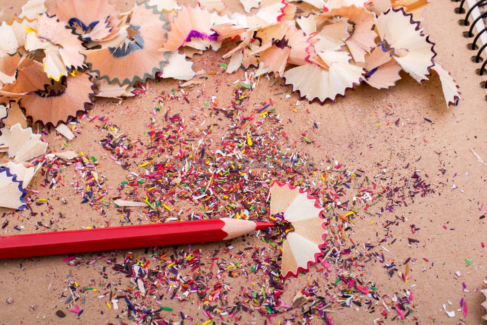 Red Color Pencil over some  pencil shavings