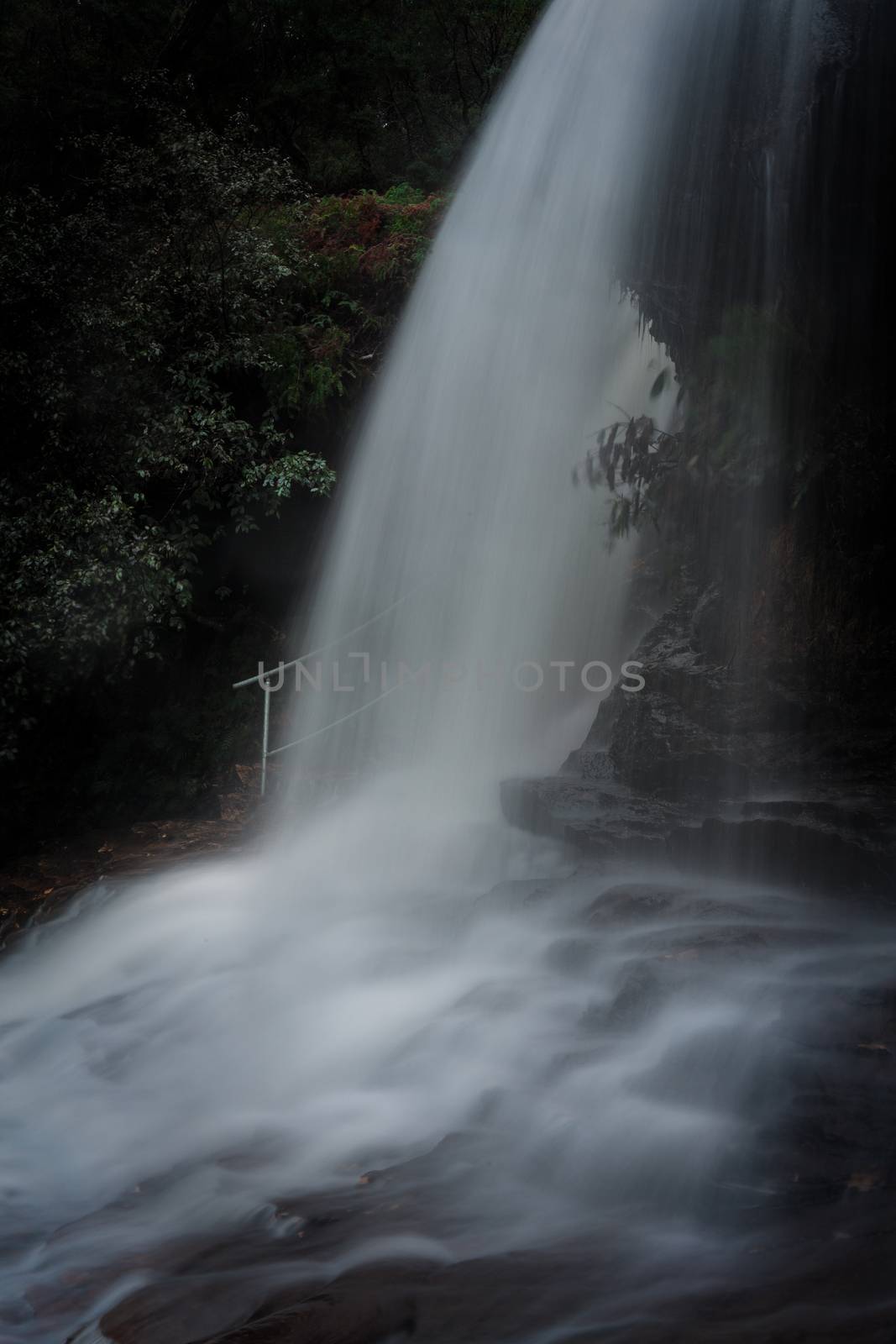 A white veil of water flows and cascades in the Blue Mountains