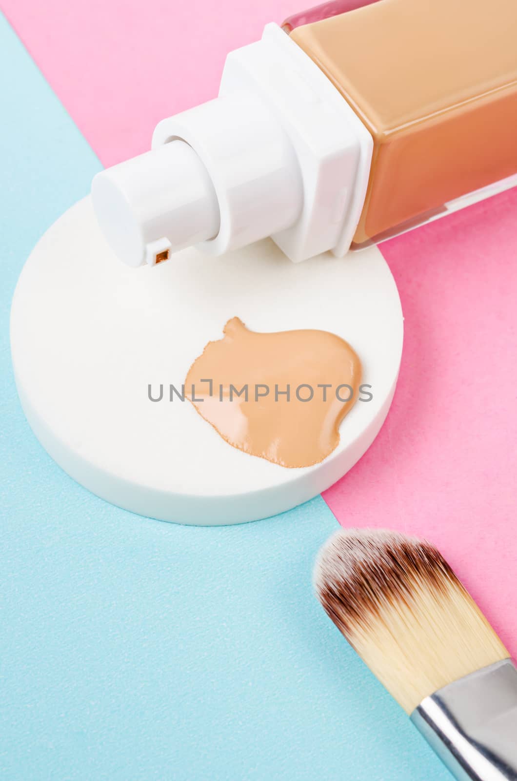 Liquid foundation makeup with brush and sponge on beautiful background;