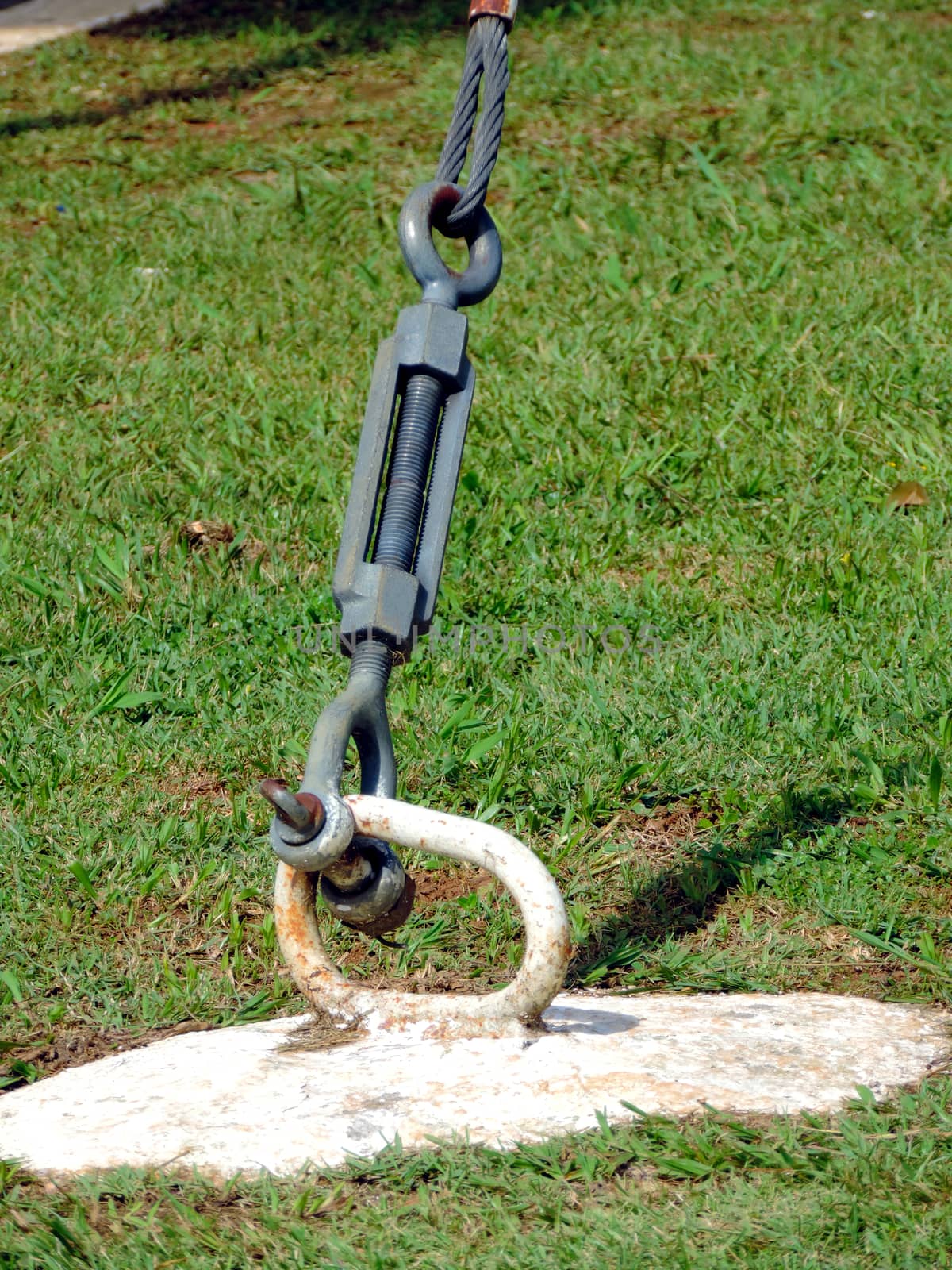 Metal and rusty anchor attached to the ground